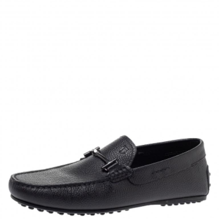 The charm of these loafers is the comfort factor and the double T accent on the uppers. Made from navy blue leather, these shoes by Tod's are set on pebbled soles and shaped to cover your feet with luxurious ease.