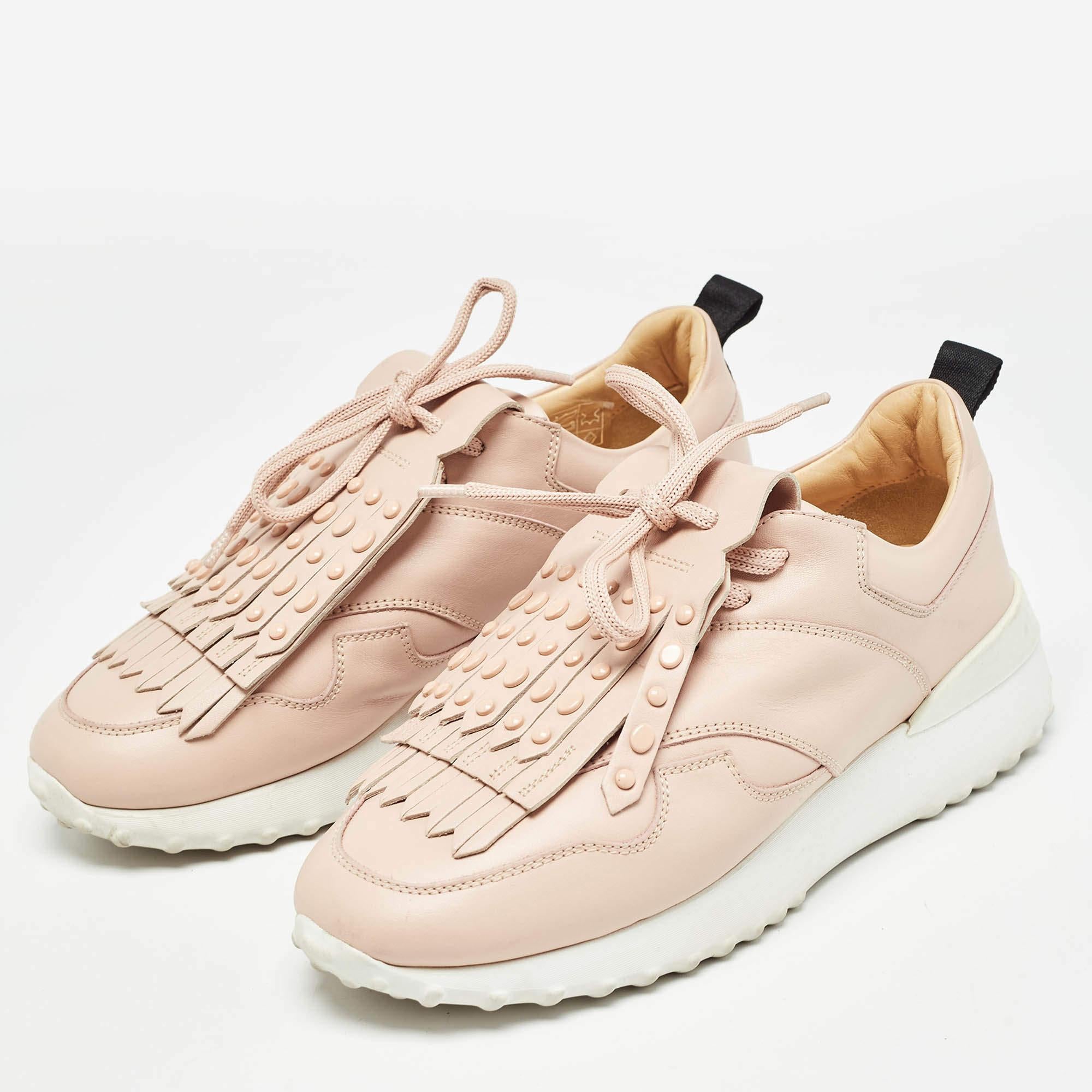 Make a style statement every time you wear these trendy Tods slip on sneakers. Theyve been crafted from pink leather and styled with fringes on the uppers. Leather insoles and rubber soles wonderfully complete the pair.