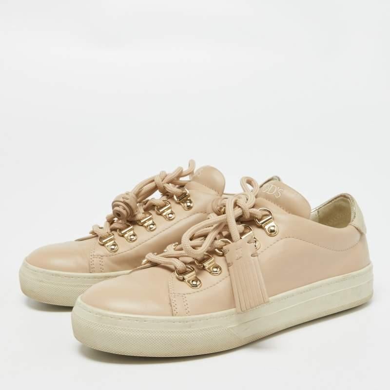 Packed with style and comfort  these Tods sneakers are gentle on the feet so that you can glide through the day. They have a sleek upper with lace closure  and theyre set on durable rubber soles.