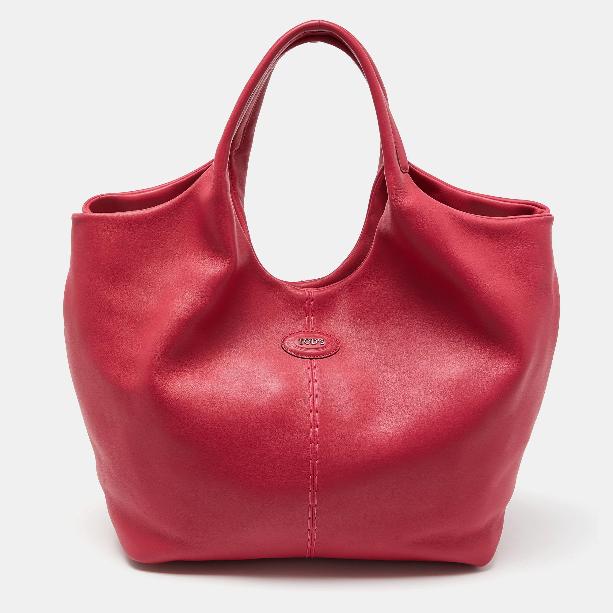 This stylish tote from Tod's is perfect for everyday use. Crafted from leather, the bag features dual handles and protective feet at the bottom. The tote comes with a nylon-lined interior to safely store your necessities.

Includes: Original