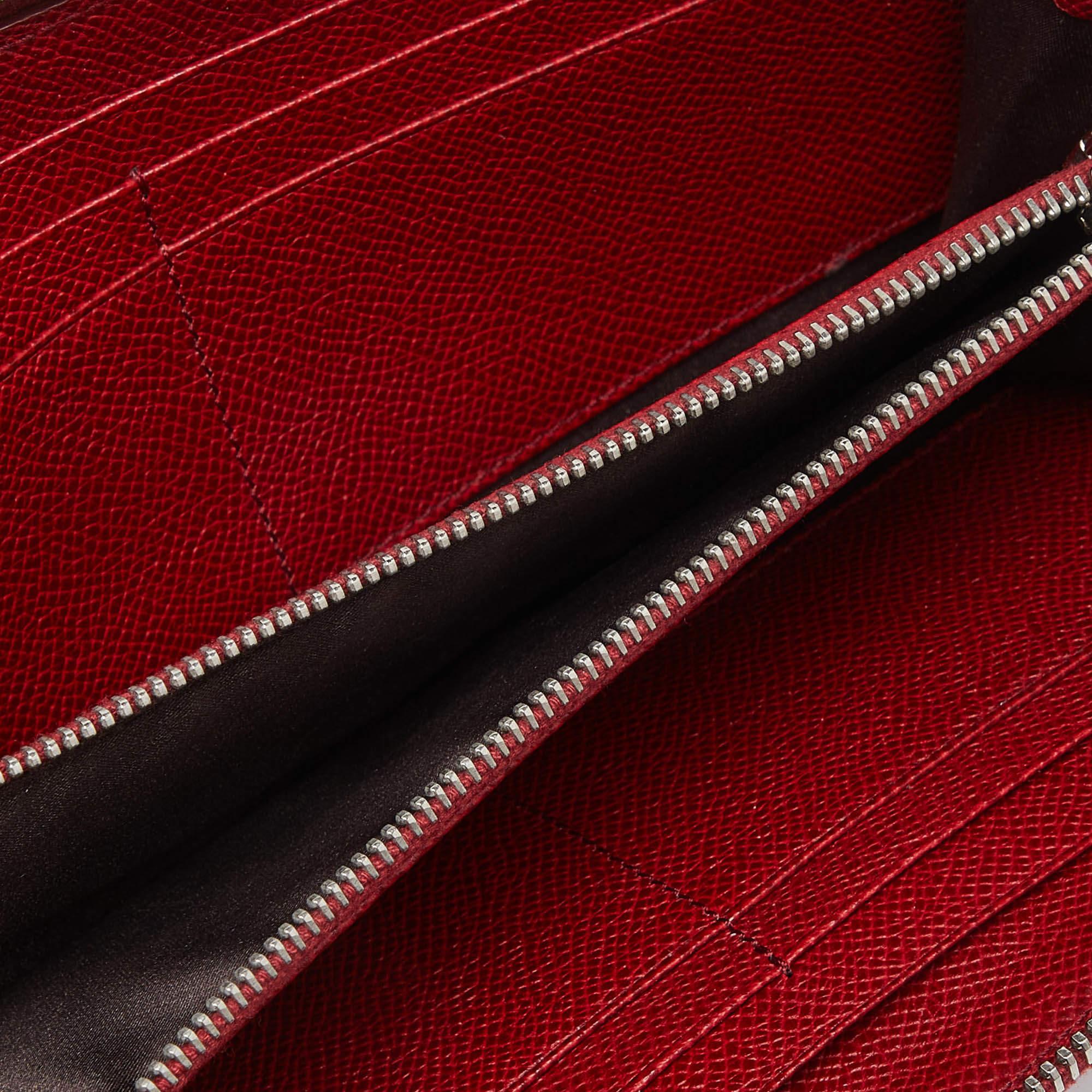 This Tods red wallet effortlessly combines meticulous construction with ageless style  making it a symbol of refined taste. Elevate your accessory collection with this designer piece.
