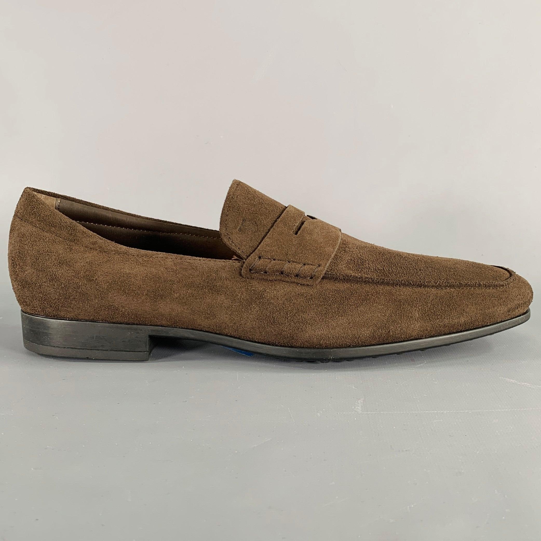 TOD'S loafers in a dark brown suede featuring a penny style, and slip on closure. Comes with box. Made in Italy.Excellent Pre-Owned Condition. 

Marked:   UK 9.5Outsole: 11.75 inches  x 3.75 inches 
  
  
 
Sui Generis Reference: 133181
Category: