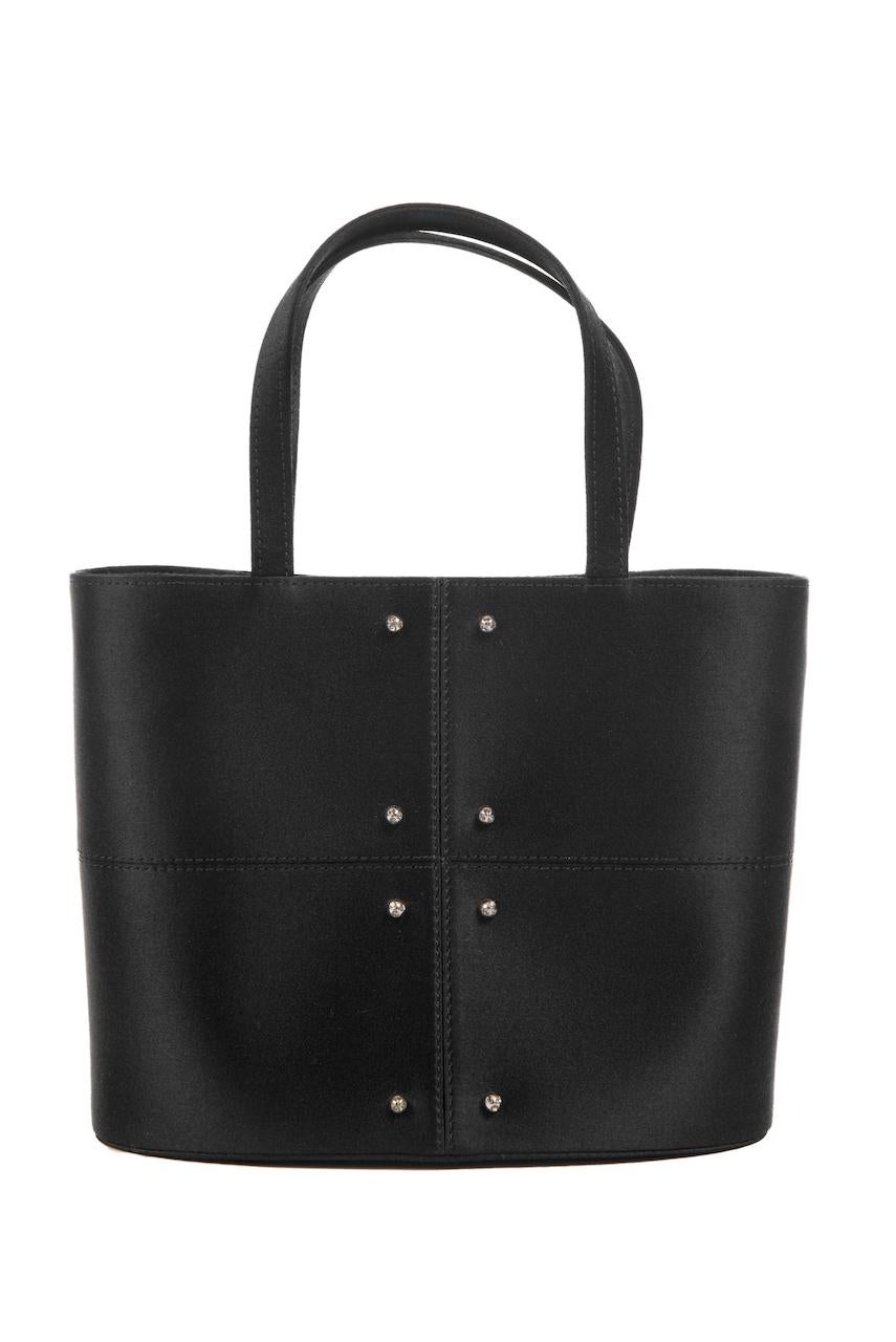This elegant and minimalist late 1990s top handle evening handbag by Tod's is large enough for all of your evening essentials, but small enough to carry in your hand. It features a black softly shimmering silk satin body with beautiful seaming