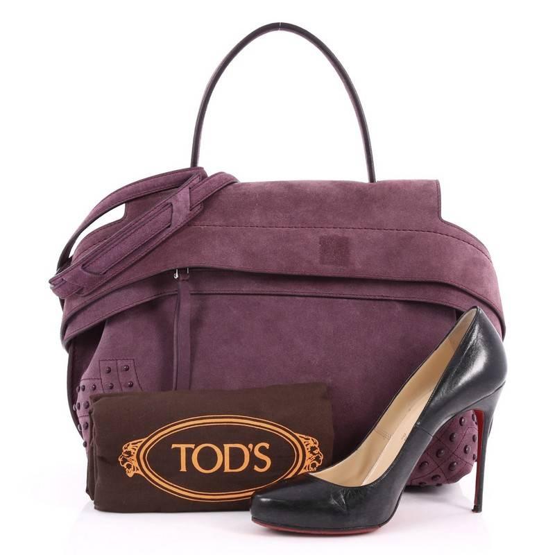 This authentic Tod's Studded Convertible Wave Bag Suede Medium is perfect for the modern fashionista. Crafted from purple suede, this bag features a flat suede top handle, removable strap, stamped Tod's logo, wide front leather band with button