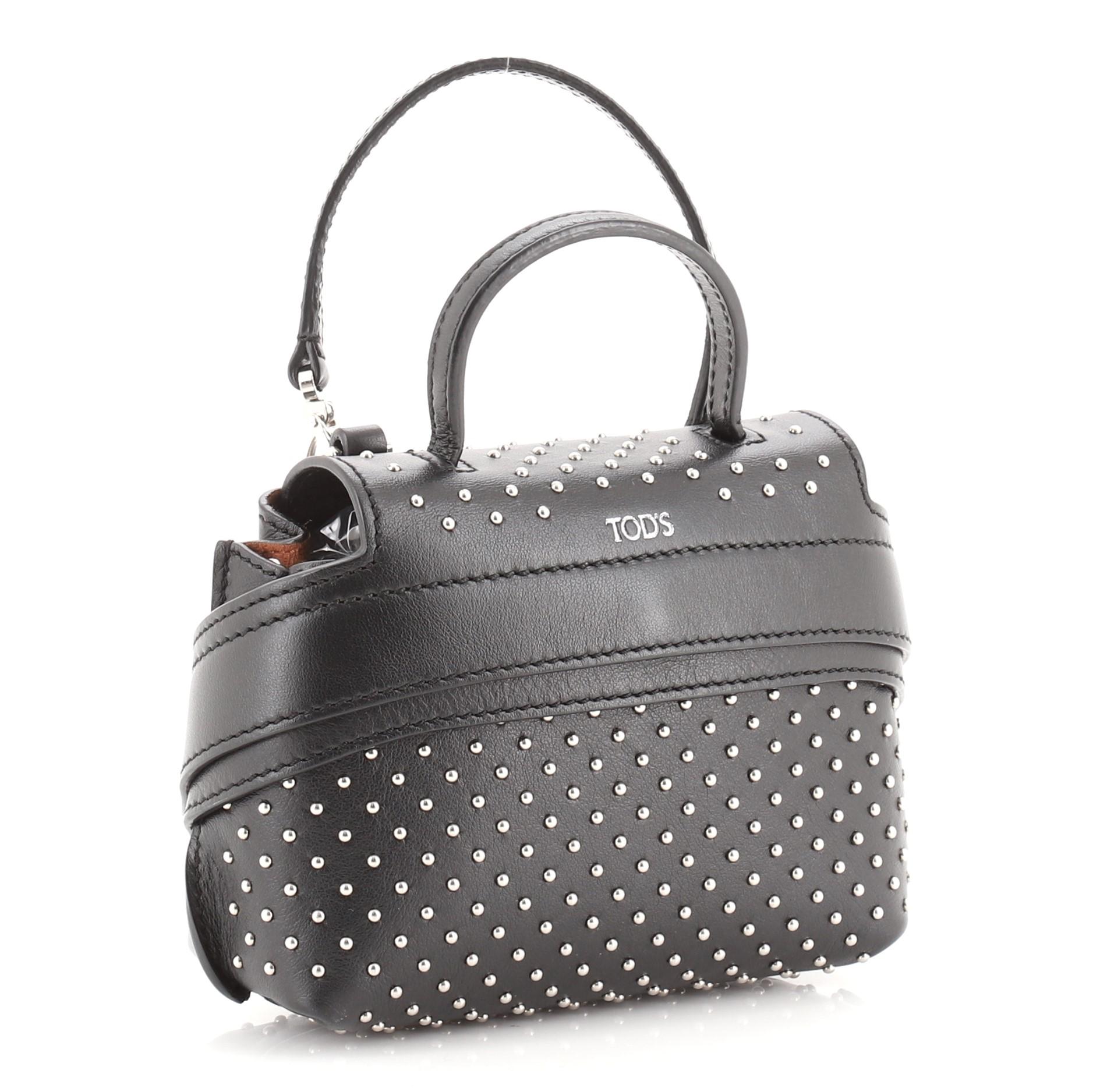 Tod's Studded Wave Charm Bag Leather
Black

Condition Details: Minor wear on exterior, handle and in interior, creasing on flap and underneath flap, scratches on hardware.

52319MSC

Height 4.5
