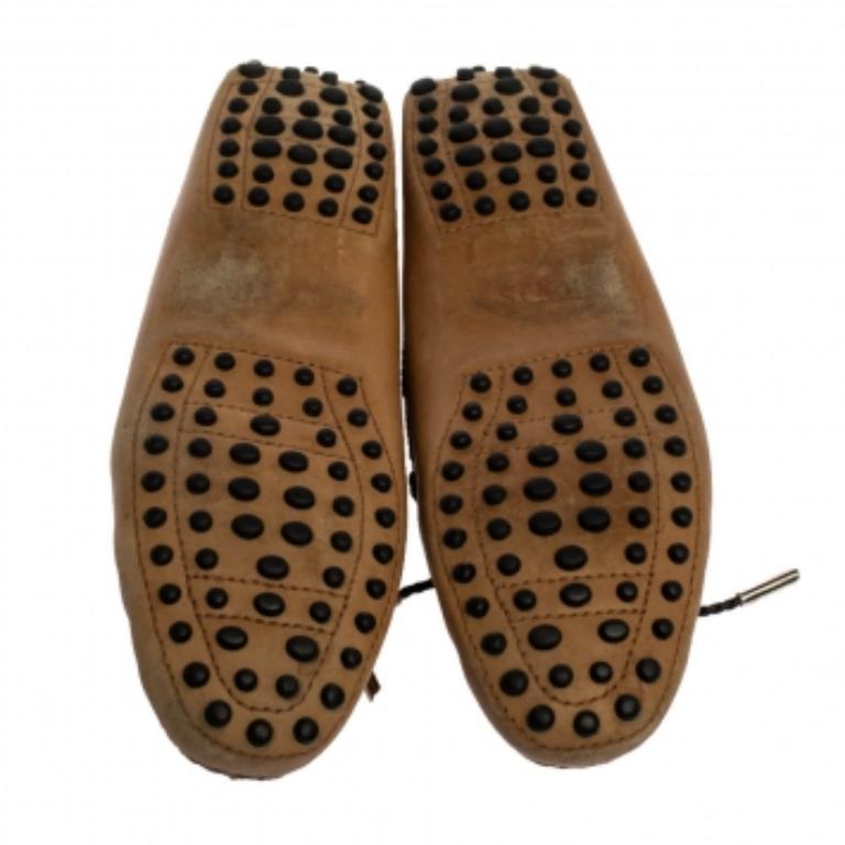 Add value to your ensemble by slipping into this pair of loafers from Tod's. Made from tan leather, they feature braided bow details on the uppers and leather lining. Soft and plush, these shoes are sure to bring you comfort.