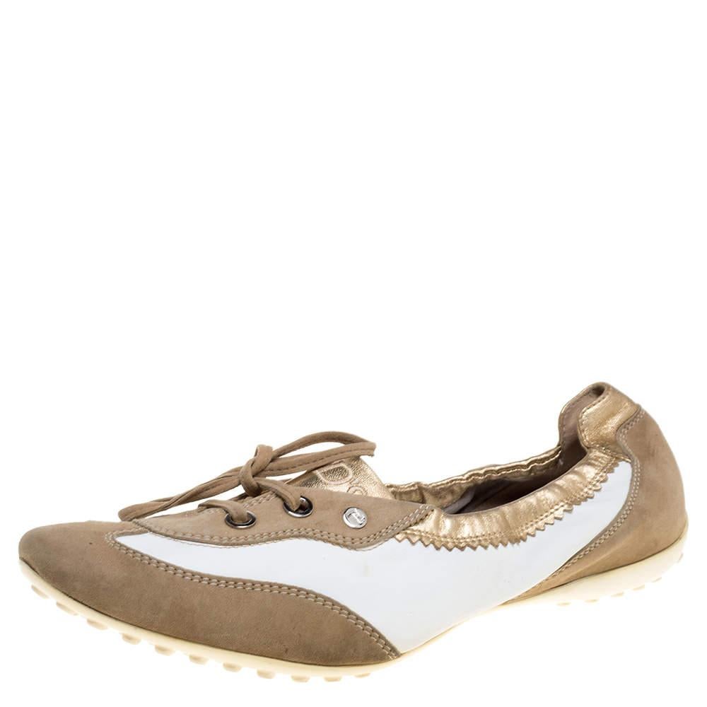 Offering both comfort and style, these slip-on sneakers from Tod's are worth the buy! They are crafted from leather and suede and styled with round toes, lace-ups on the vamps, and the brand logo on the counters. They are equipped with leather-lined