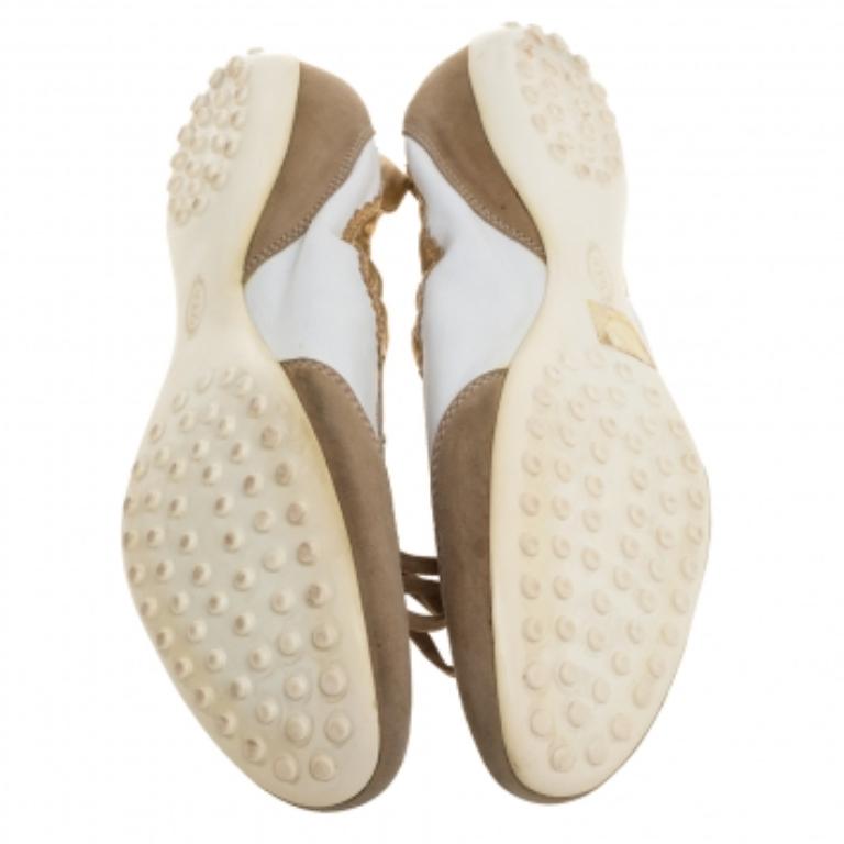 Offering both comfort and style, these slip-on sneakers from Tod's are worth the buy! They are crafted from leather and suede and styled with round toes, lace-ups on the vamps, and the brand logo on the counters. They are equipped with leather-lined