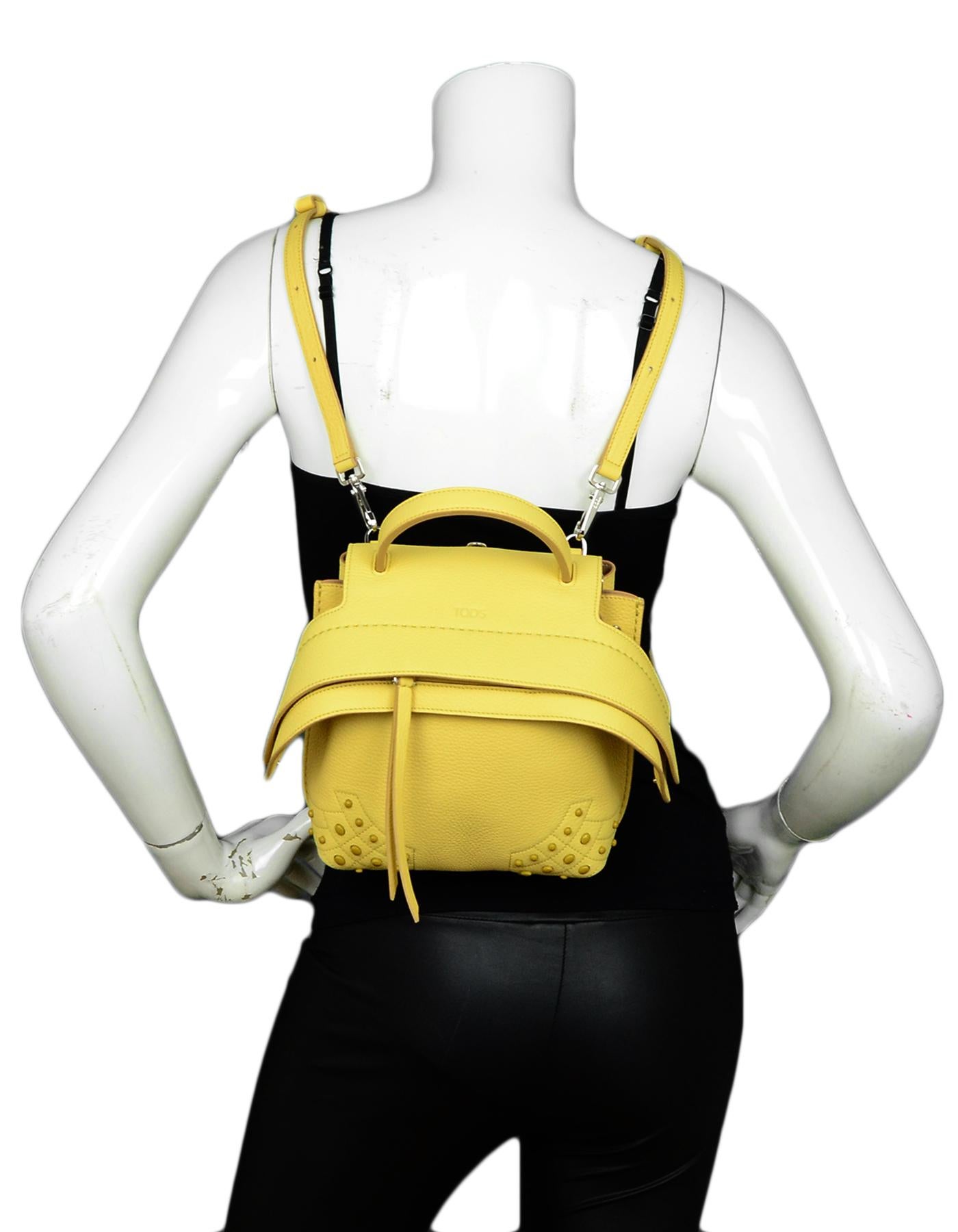 Tod's Yellow Wave Leather Convertible Mini Backpack Bag

Made In: Italy
Color: Yellow
Hardware: Silvertone
Materials: Leather
Lining: Suede
Closure/Opening: Top zip
Exterior Pockets: One flat pocket with snap closure
Interior Pockets: One flat
