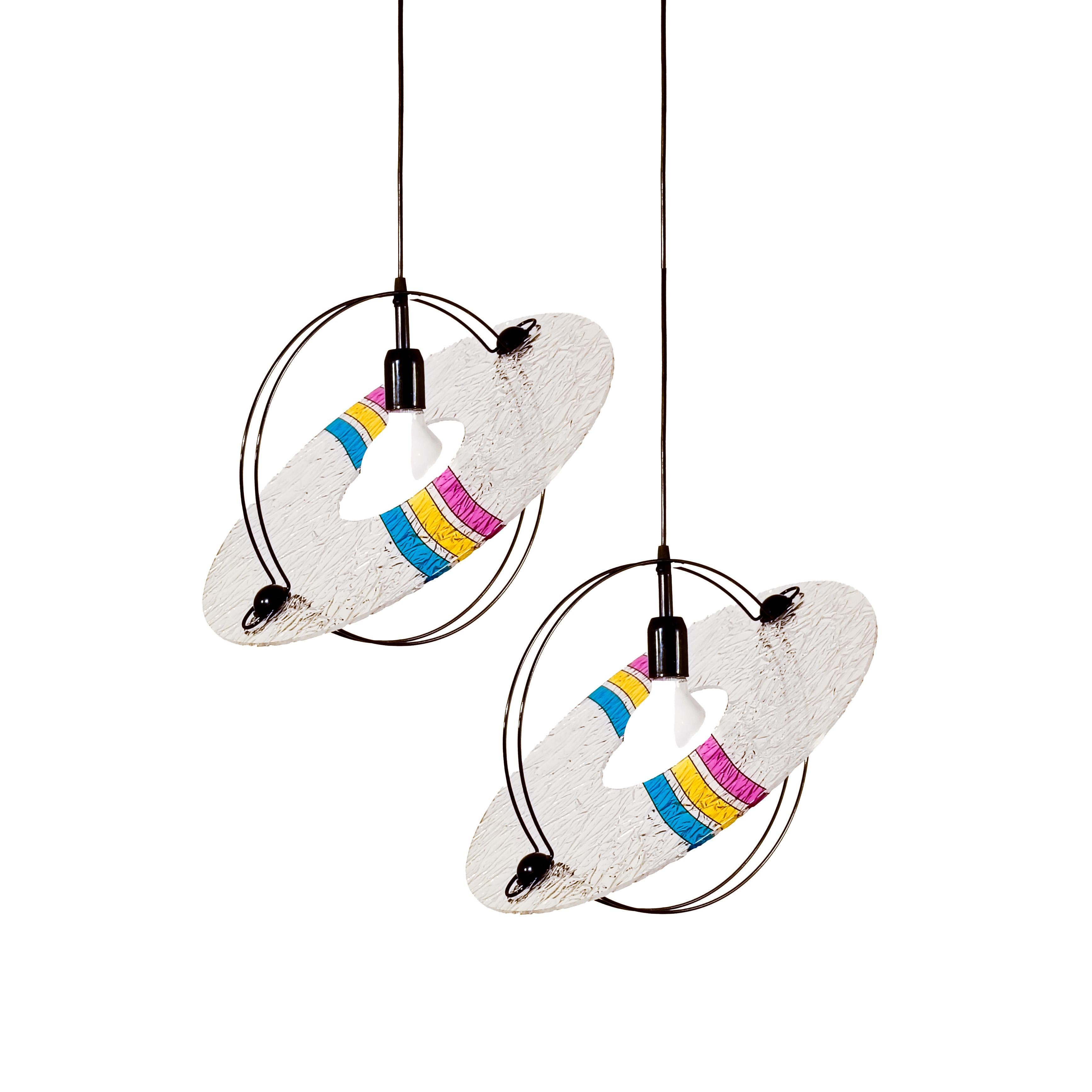 Memphis and Pop Art style pendant lamp from Toffoli, Italy, 1980s. Formed by a transparent textured methacrylate or acrylic disc with 3 colored bands and a black lacquered metal structure. Its shape is reminiscent of the planet Saturn, which gives
