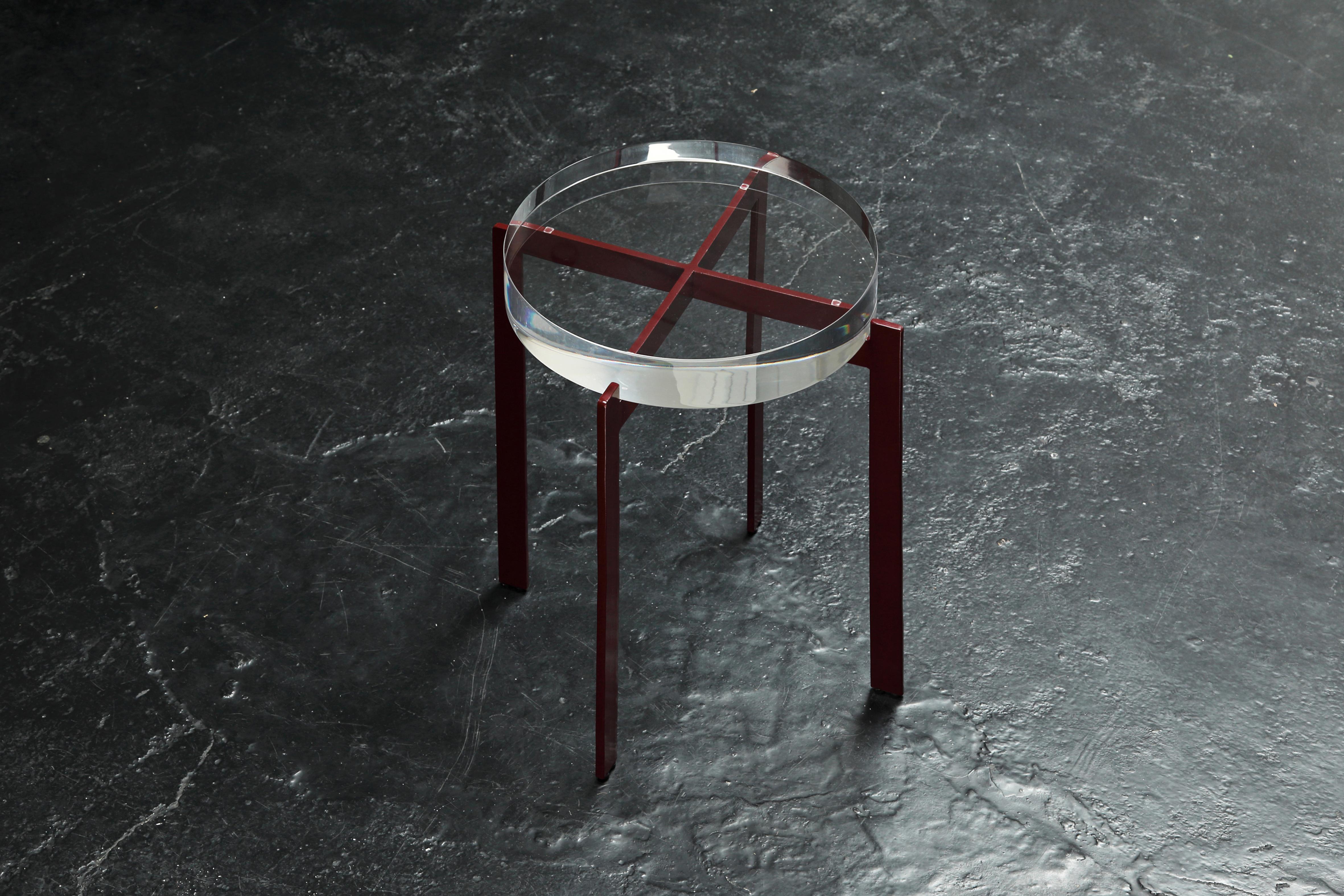 T of top table, is a modern / minimal side or bedside table with a round transparent acrylic top, resting on a metallic X-shaped base. It comes in a Royal red or black powder coated finish.

Dimensions 41 W x 41 D x 47 H cm (acrylic top 5 cm