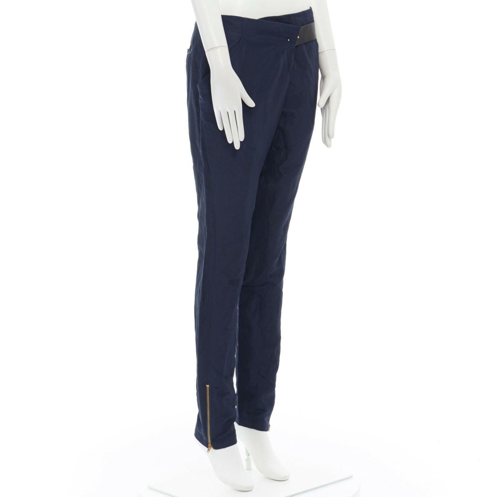 TOGA ARCHIVES navy blue faux leather belt fold over waist zip hem pants JP1 S 
Reference: JETI/A00104 
Brand: Toga Archives 
Material: Nylon 
Color: Blue 
Pattern: Solid 
Closure: Zip 
Extra Detail: Nylon blend. Navy blue. Fold over waist detail.