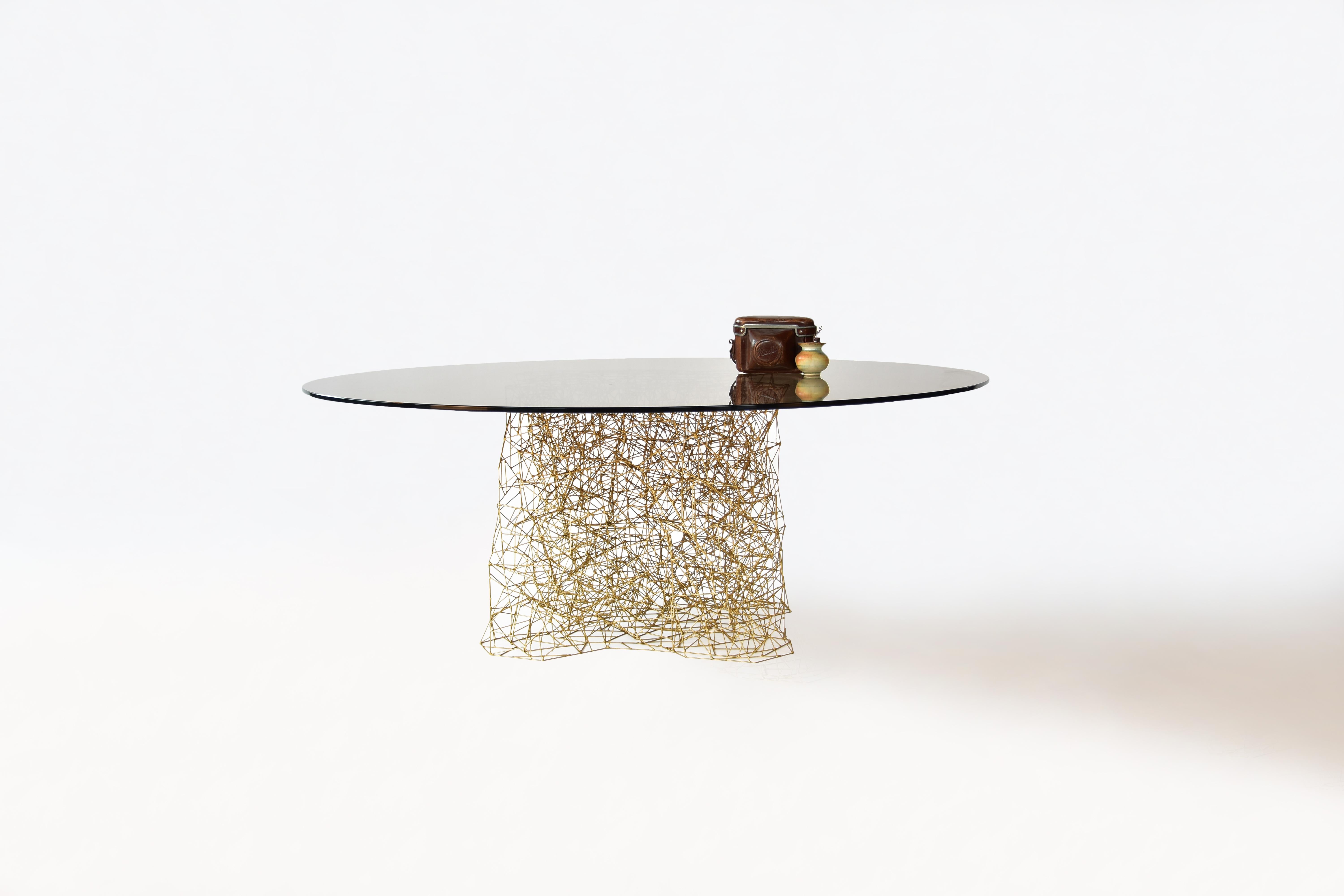 Together table by Eichkorn
Dimensions: D 100 x H 38
Materials: copper rods, bronce tinted glass plate.
Available in coffee table or in dining table size.

More than 1000 copper rods are individually assembled by hand to the desired shape. Only