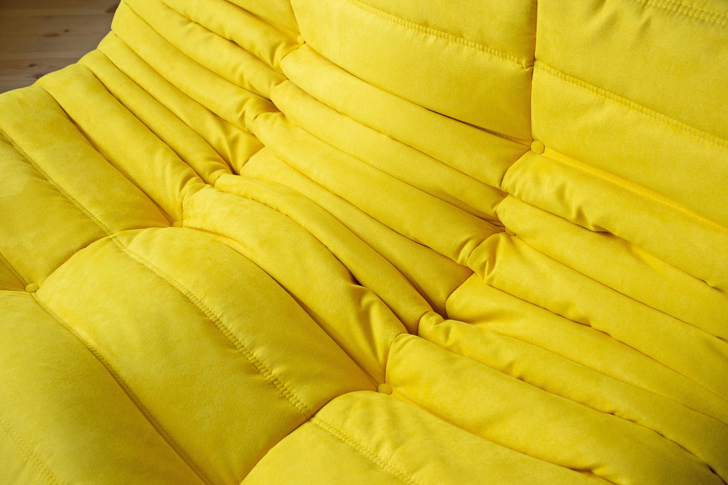 This togo two-seat couch was designed by Michel Ducaroy in 1973 and was manufactured by Ligne Roset in France. It has been reupholstered in new yellow microfibre (131 x 102 x 70 cm). It has the original Ligne Roset logo and genuine Ligne Roset