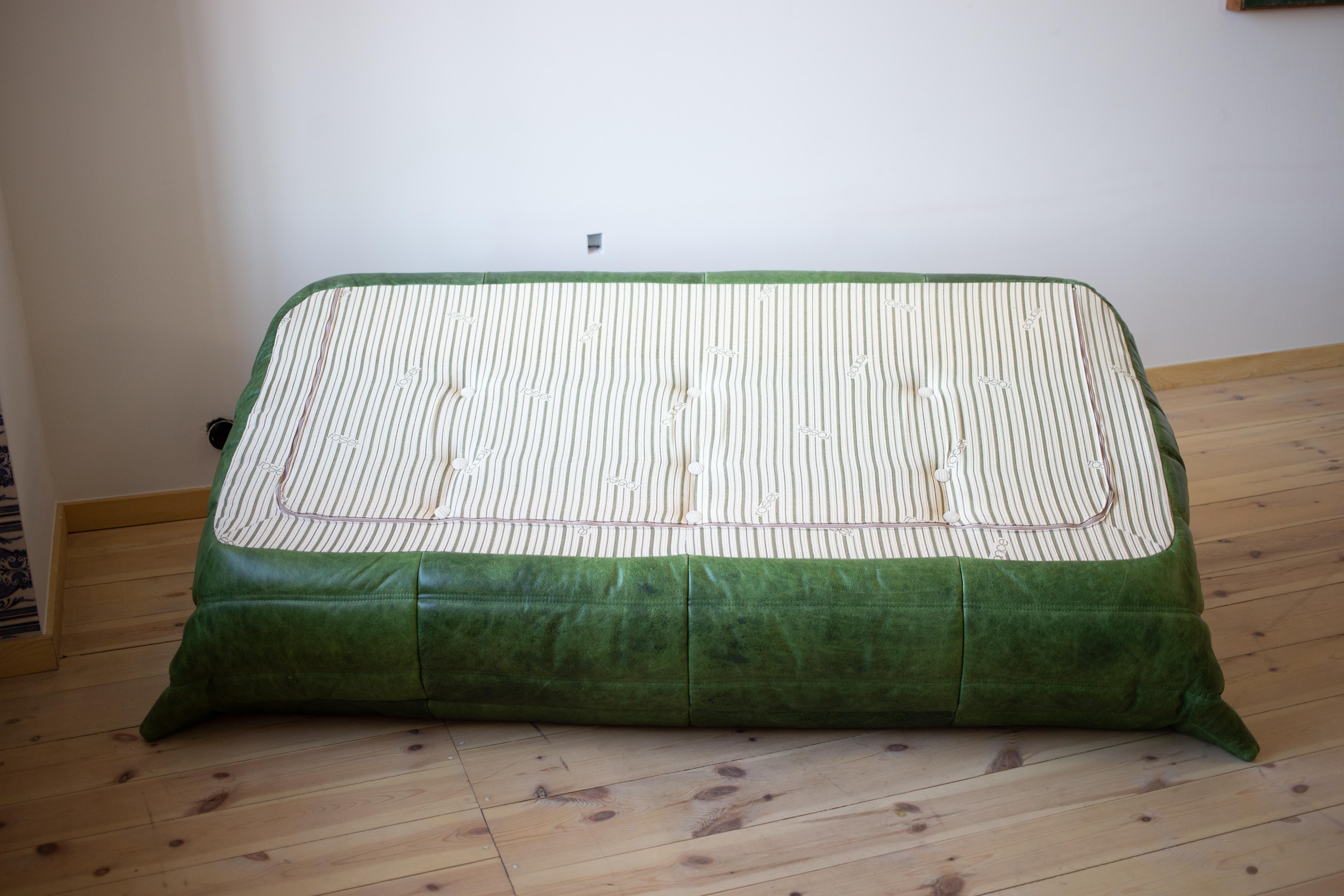 This Togo three-seat sofa was designed by Michel Ducaroy in 1973 and was manufactured by Ligne Roset in France. It has been reupholstered in Dubai Green Leather (70 x 174 x 102 cm). It has the original Ligne Roset logo and genuine Ligne Roset bottom.