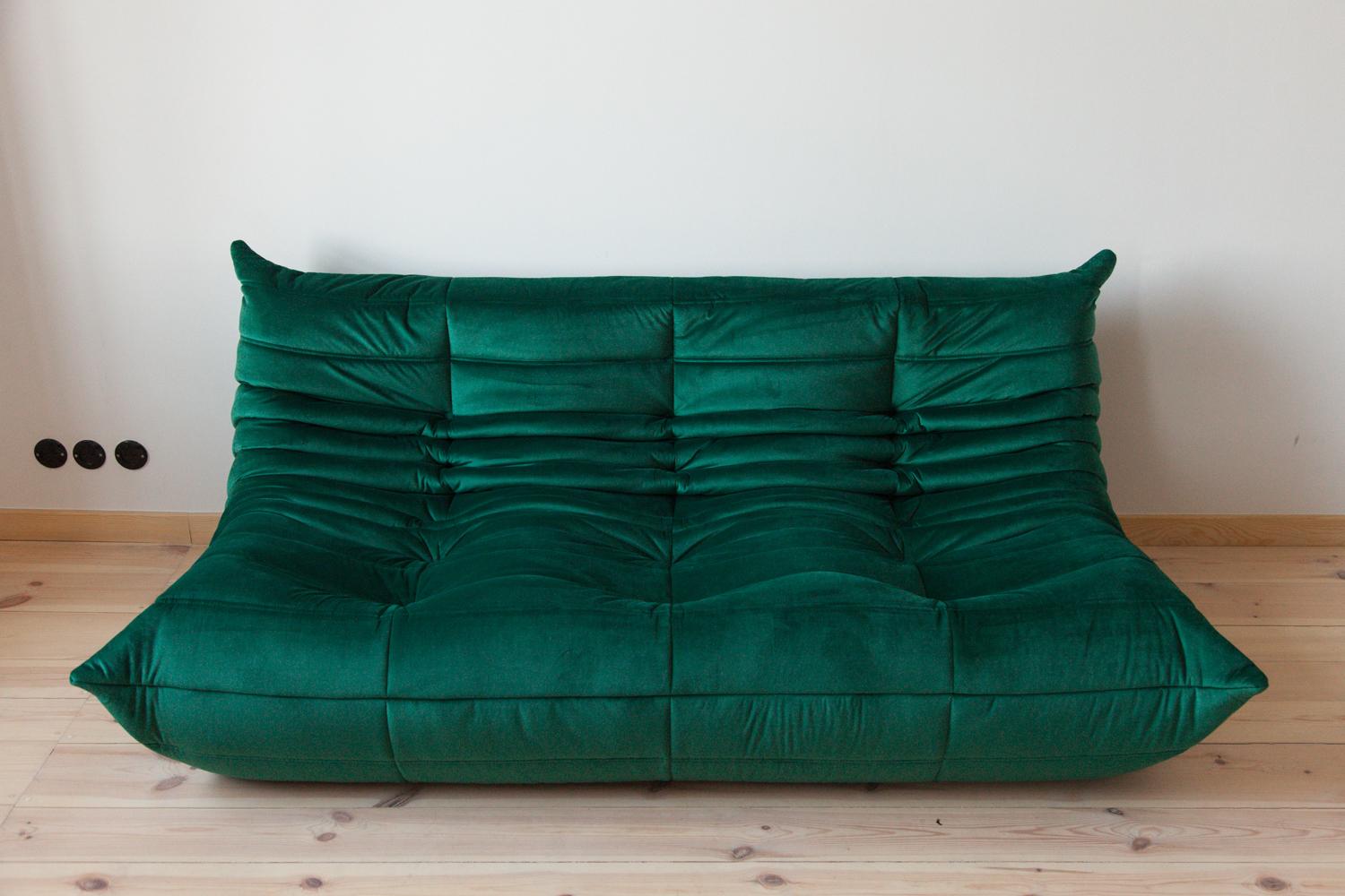 This Togo three-seat sofa was designed by Michel Ducaroy in 1973 and was manufactured by Ligne Roset in France. It has been reupholstered in new bottle green velvet (70 x 174 x 102 cm). It has the original Ligne Roset logo and genuine Ligne Roset