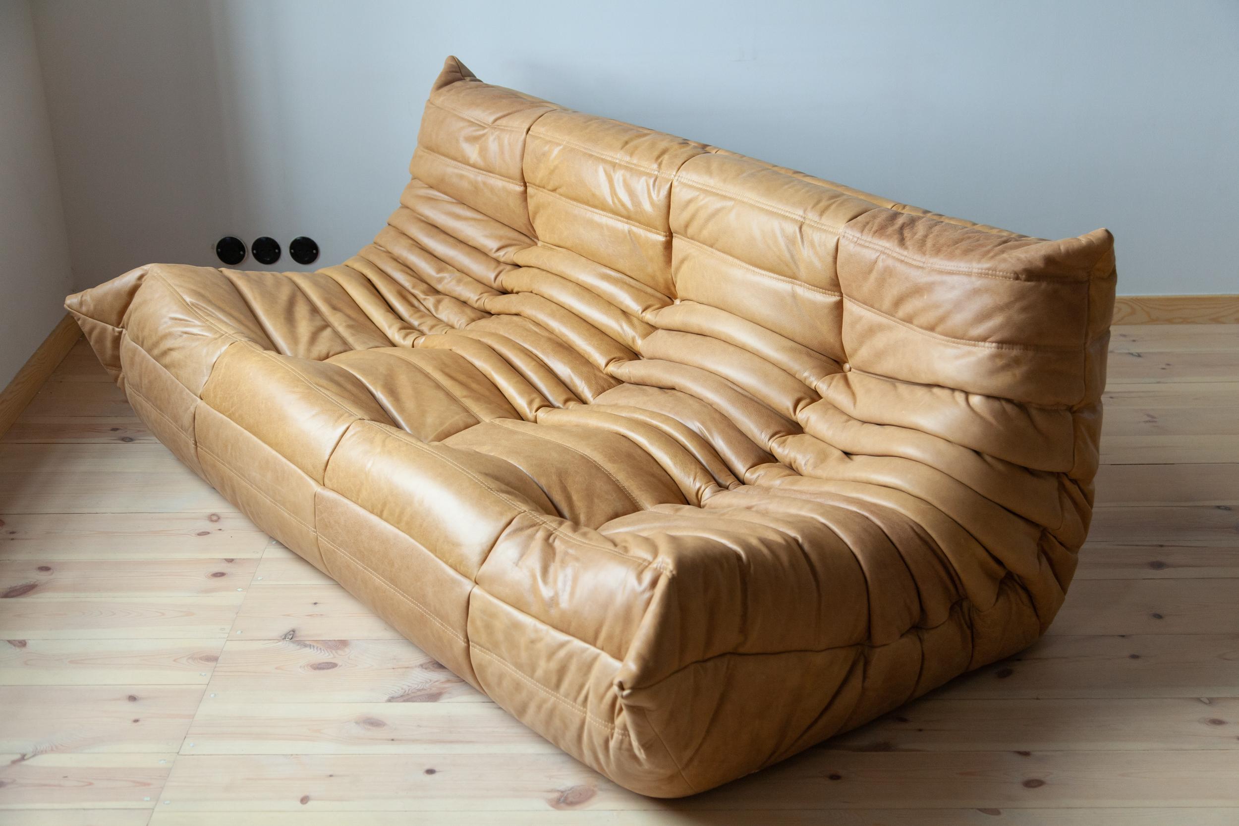 This Togo three-seat sofa was designed by Michel Ducaroy in 1973 and was manufactured by Ligne Roset in France. It has been reupholstered in new camel brown leather (70 x 174 x 102 cm). It has the original Ligne Roset logo and genuine Ligne Roset