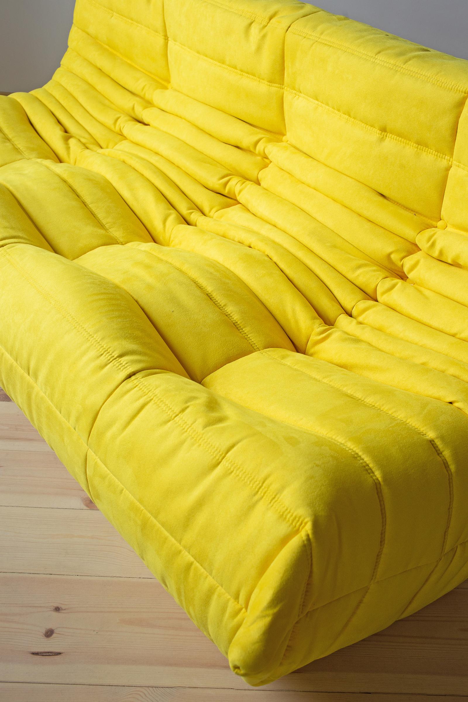 This togo three-seat sofa was designed by Michel Ducaroy in 1973 and was manufactured by Ligne Roset in France. It has been reupholstered in new yellow microfibre (70 x 174 x 102 cm). It has the original Ligne Roset logo and genuine Ligne Roset