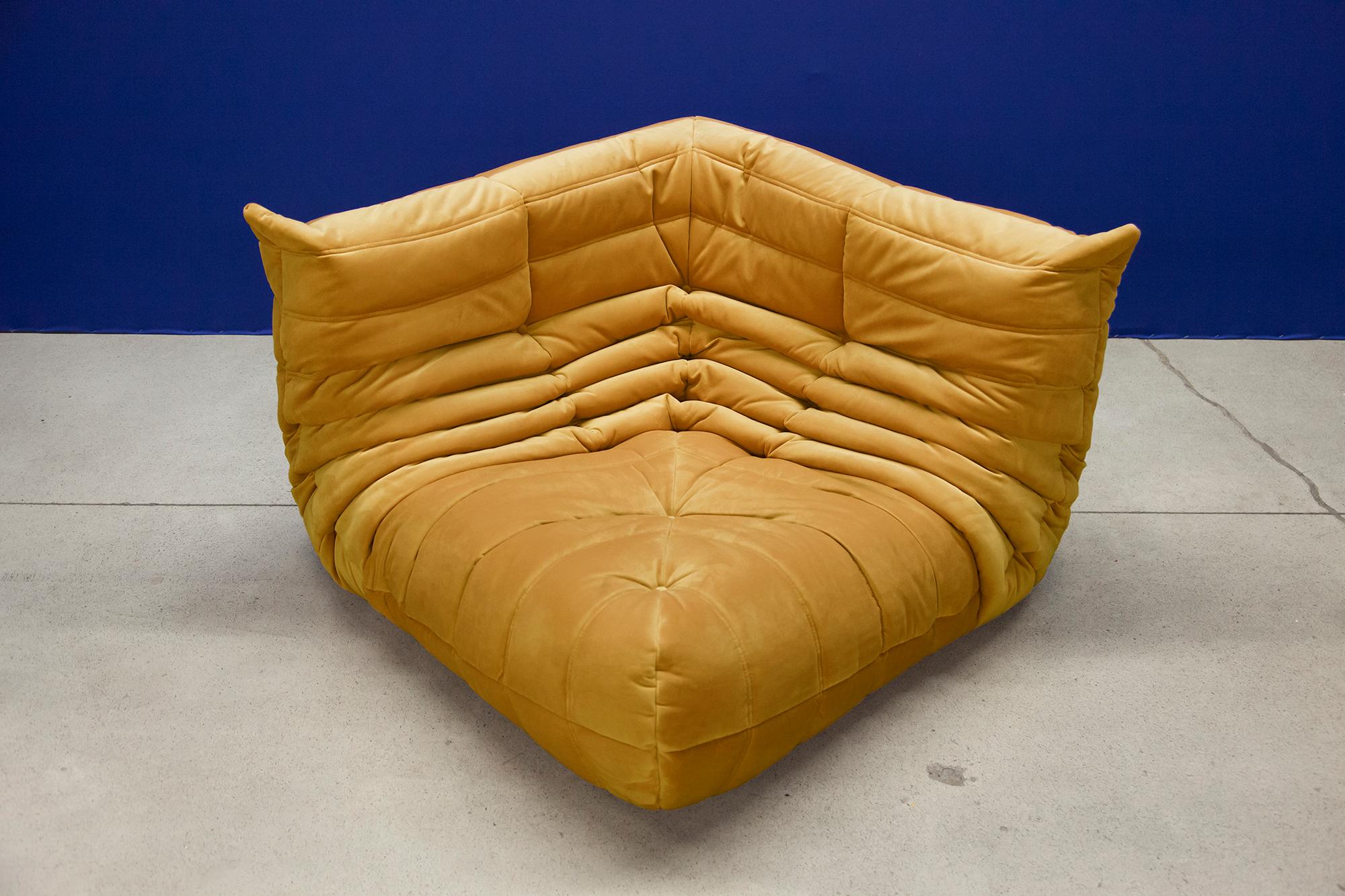 This Togo corner couch was designed by Michel Ducaroy in 1973 and was manufactured by Ligne Roset in France. It has been reupholstered in new golden yellow velvet (102 x 102 x 70 cm). It has the original Ligne Roset logo and genuine Ligne Roset