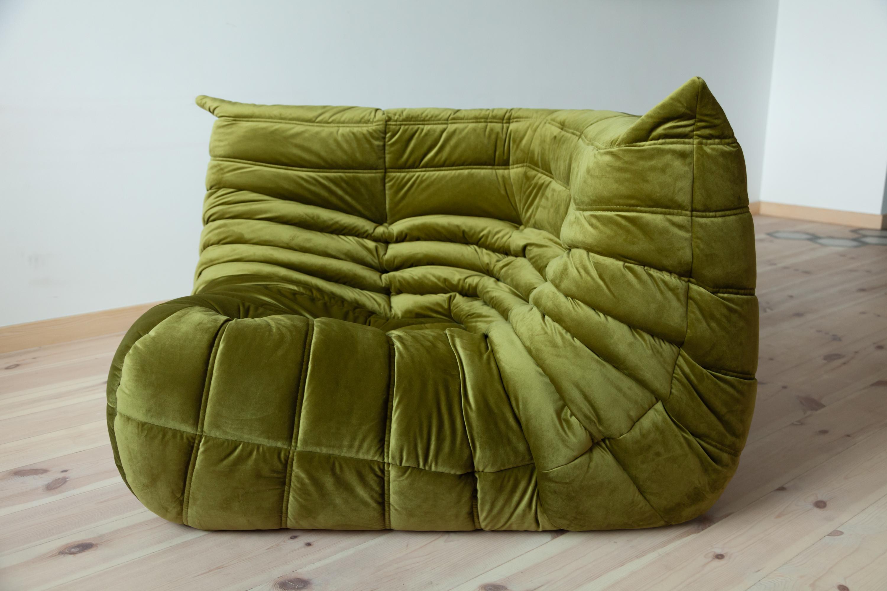 This vintage Togo corner couch was designed by Michel Ducaroy in 1973 and was manufactured by Ligne Roset in France. It has been reupholstered in new olive green velvet (102 x 102 x 70 cm). It has the original Ligne Roset logo and genuine Ligne
