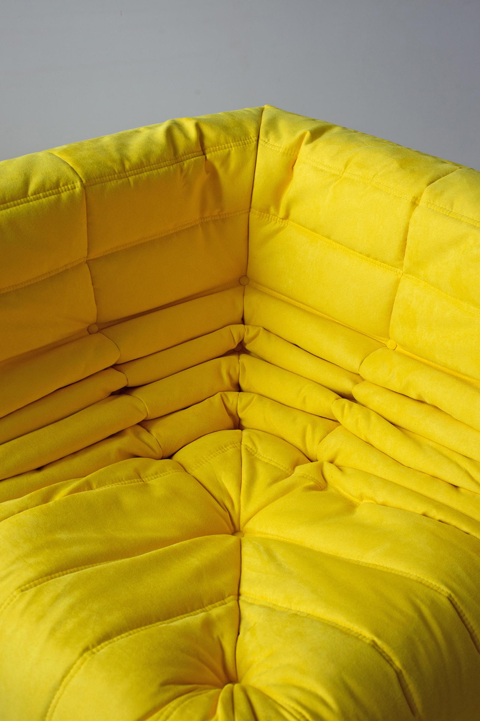 This Togo corner couch was designed by Michel Ducaroy in 1973 and was manufactured by Ligne Roset in France. It has been reupholstered in new yellow microfibre (102 x 102 x 70 cm). It has the original Ligne Roset logo and genuine Ligne Roset