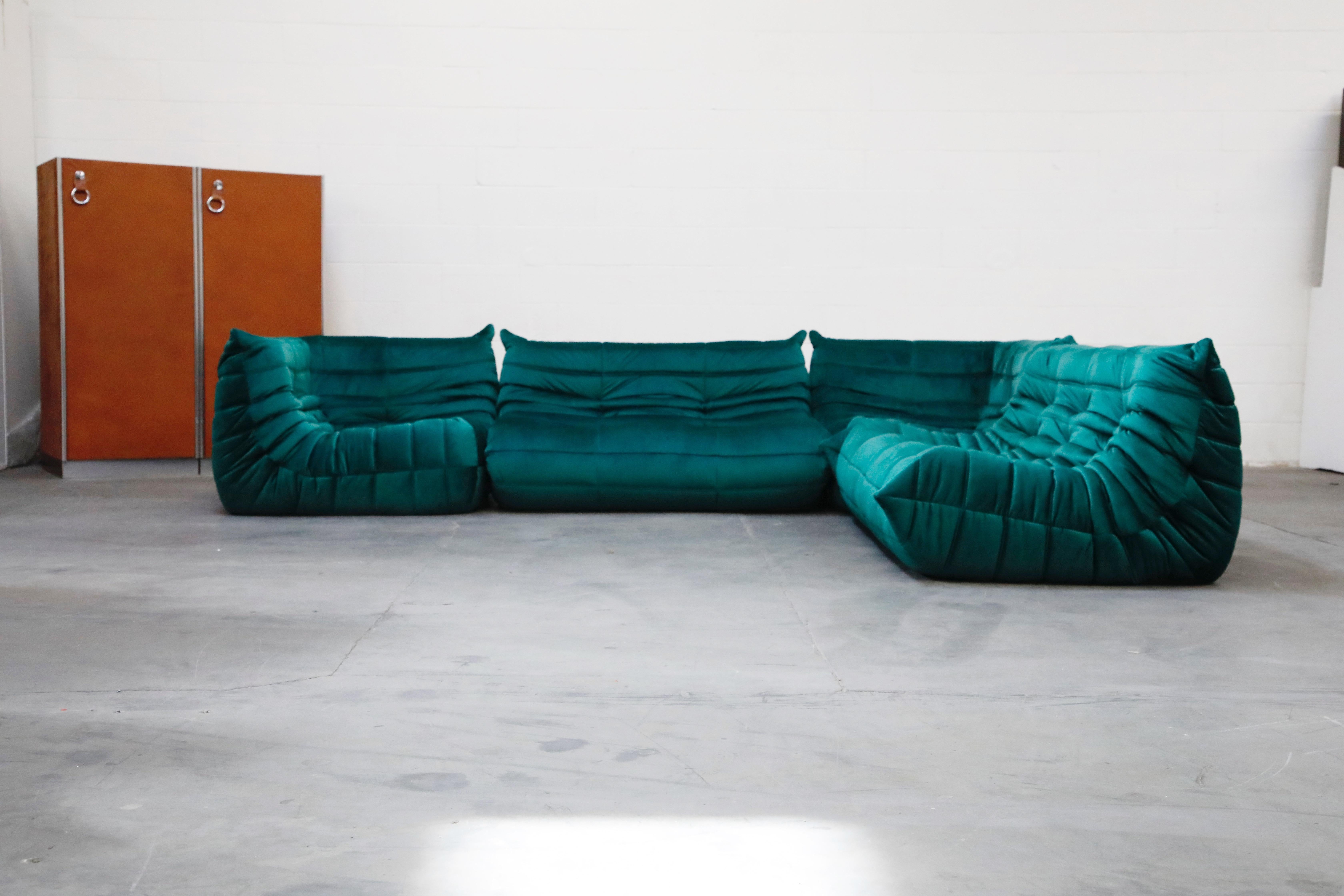 This incredible four (4) piece Togo sectional living room set, was designed by Michel Ducaroy in 1973 for Ligne Roset, France. This set was completely restored with new high grade velvet upholstery in a mesmerizing emerald green color, and bottom