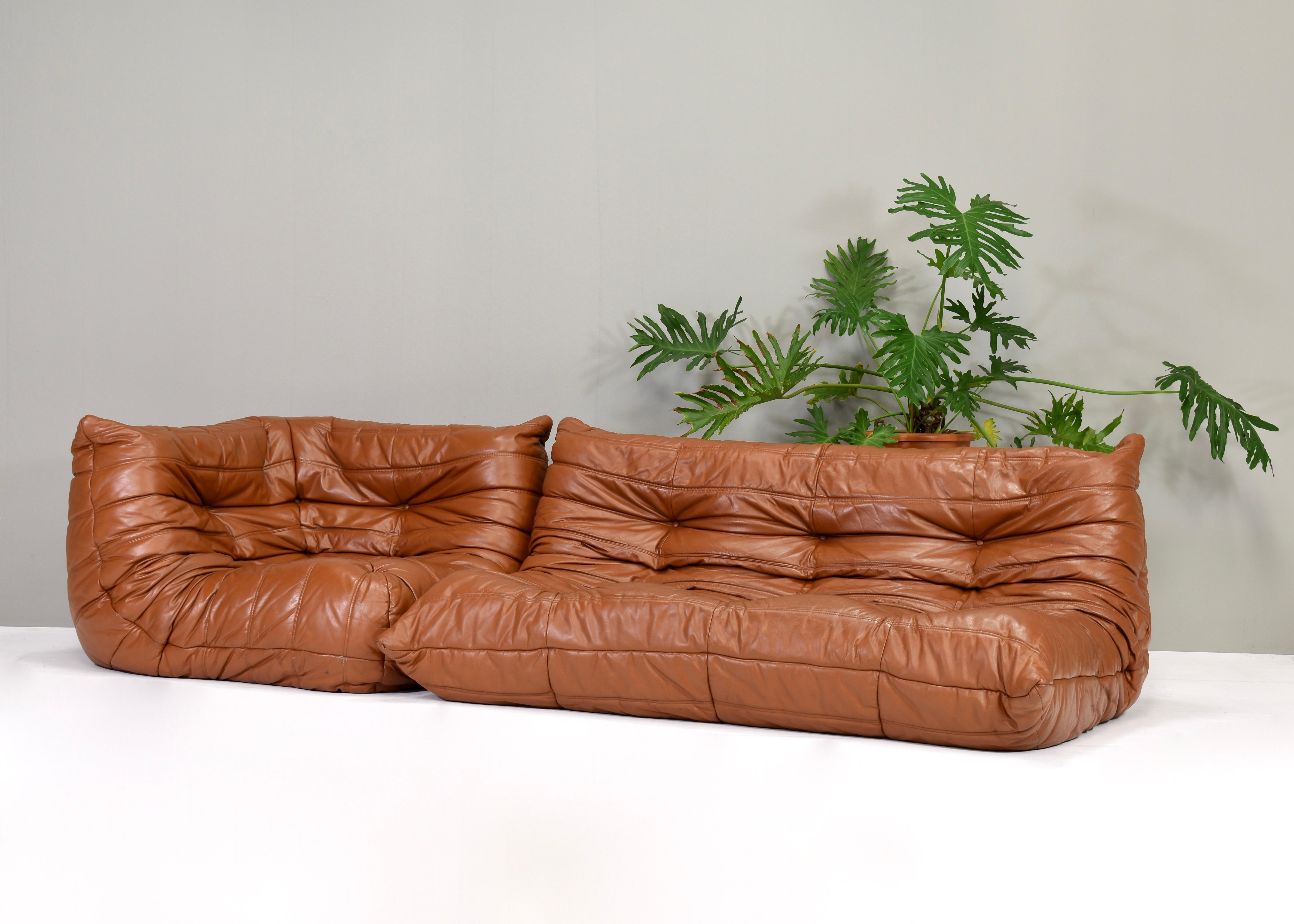 1970's period original Togo sofa and corner seat in tan / cognac leather by Michel Ducaroy for Ligne Roset, France – circa 1970. This set is period original and still remains in good condition. It has some age and use related wear to the leather.