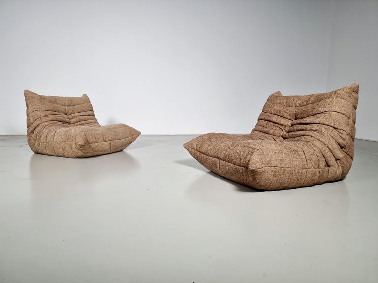 Togo lounge chairs designed by Michel Ducaroy in the 1970s for Ligne Roset.
It shows a nice warm natural color tone and its famous wrinkled cozy design.
Lined underneath with original fabric. Reupholstered in a high-quality textured fabric by Zinc