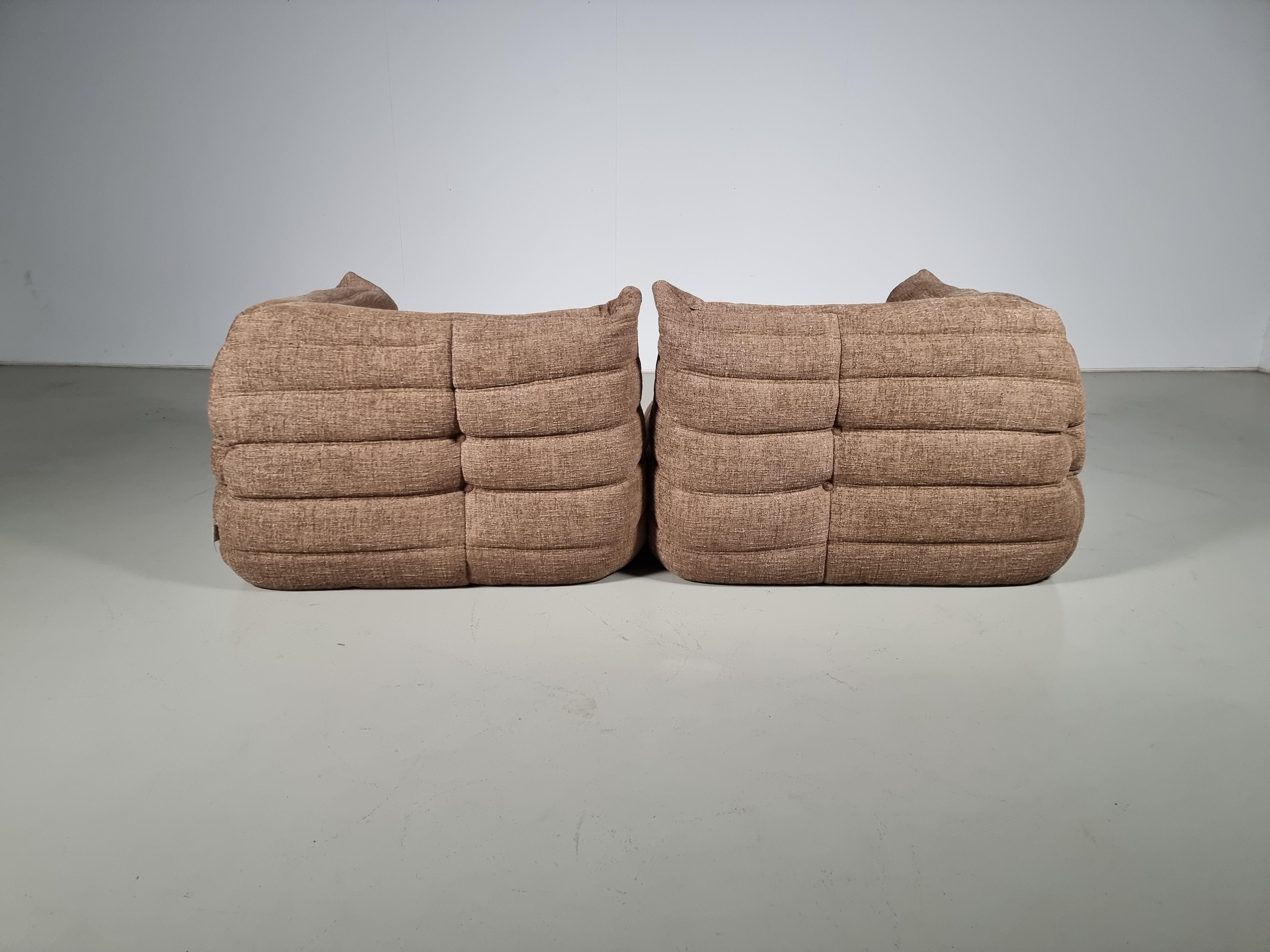 Togo lounge chairs designed by Michel Ducaroy in the 1970s for Ligne Roset.
It shows a nice warm natural color tone and its famous wrinkled cozy design.
Lined underneath with original fabric. Reupholstered in a high-quality textured fabric by Zinc
