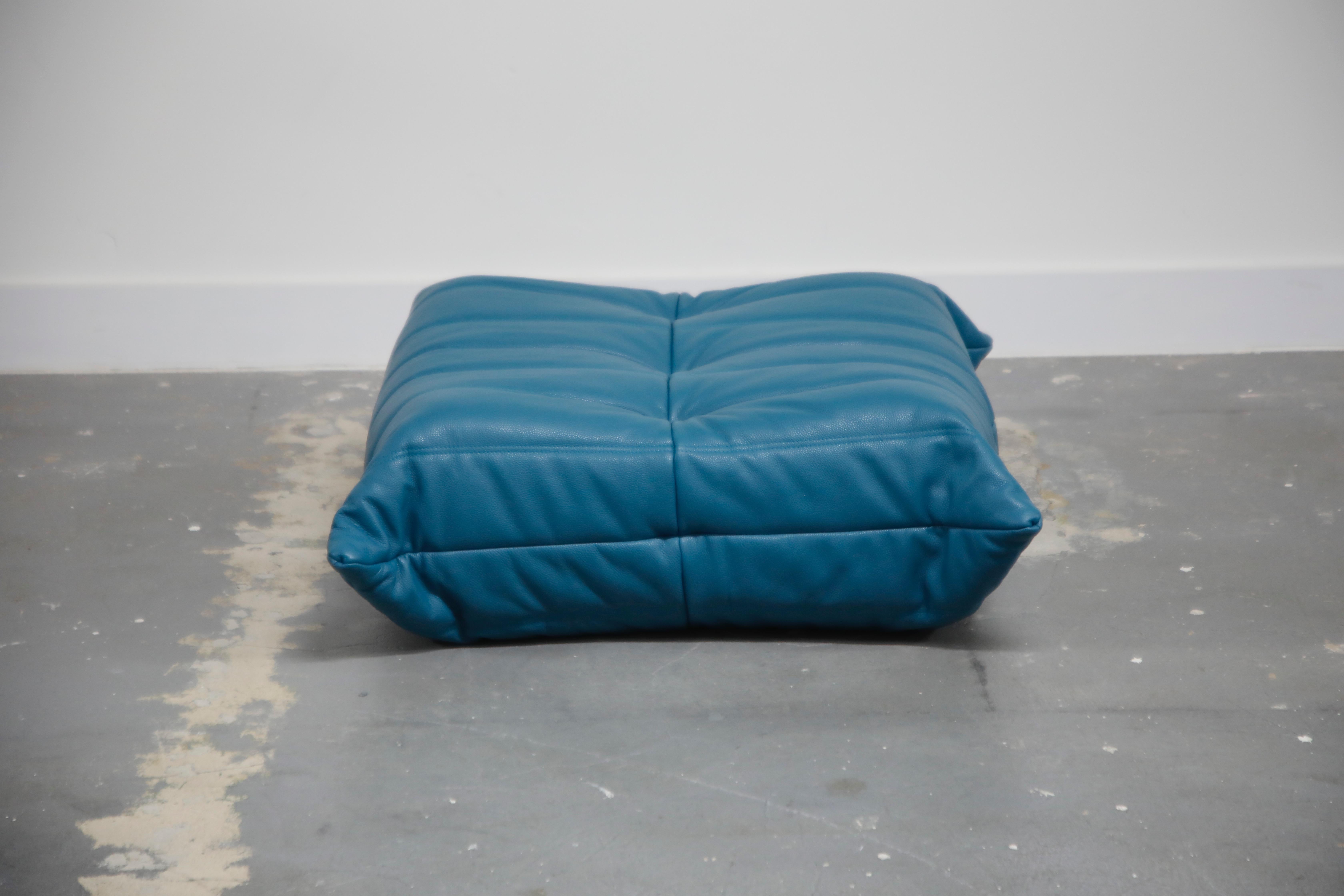 This incredible ottoman was designed by Michel Ducaroy in 1973 for Ligne Roset, France. This single piece from a larger set was completely restored with new high grade Bovine leather upholstery in a mesmerizing petrol blue color, and bottom decking