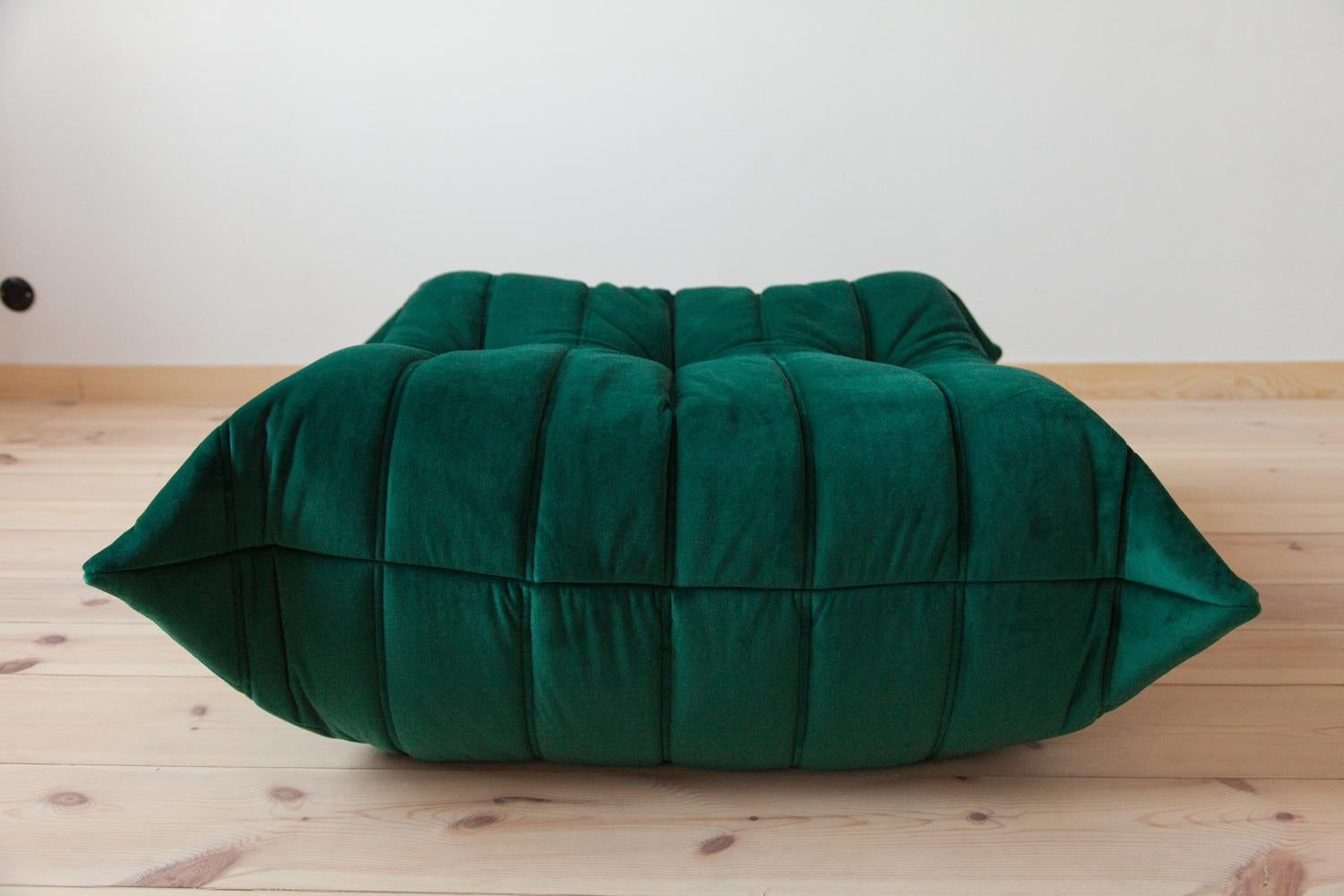 This Togo ottoman was designed by Michel Ducaroy in 1973 and was manufactured by Ligne Roset in France. It has been reupholstered in new bottle green velvet (87 x 80 x 38 cm). It has the original Ligne Roset logo and genuine Ligne Roset bottom.