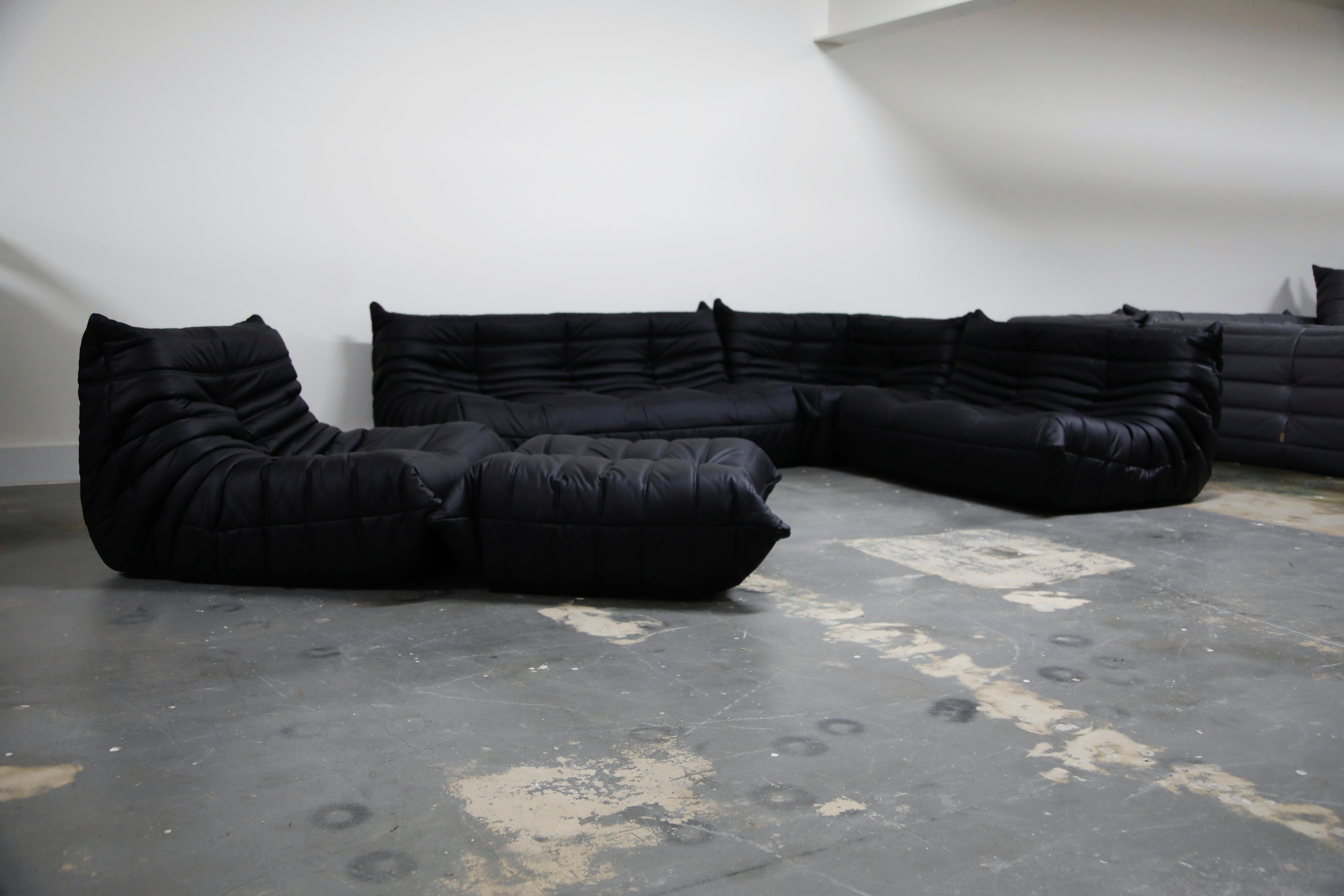 This incredible five (5) piece Togo sectional living room set, was designed by Michel Ducaroy in 1973 for Ligne Roset, France. This set was completely restored with new high grade Bovine leather upholstery in a soft black color, and bottom decking