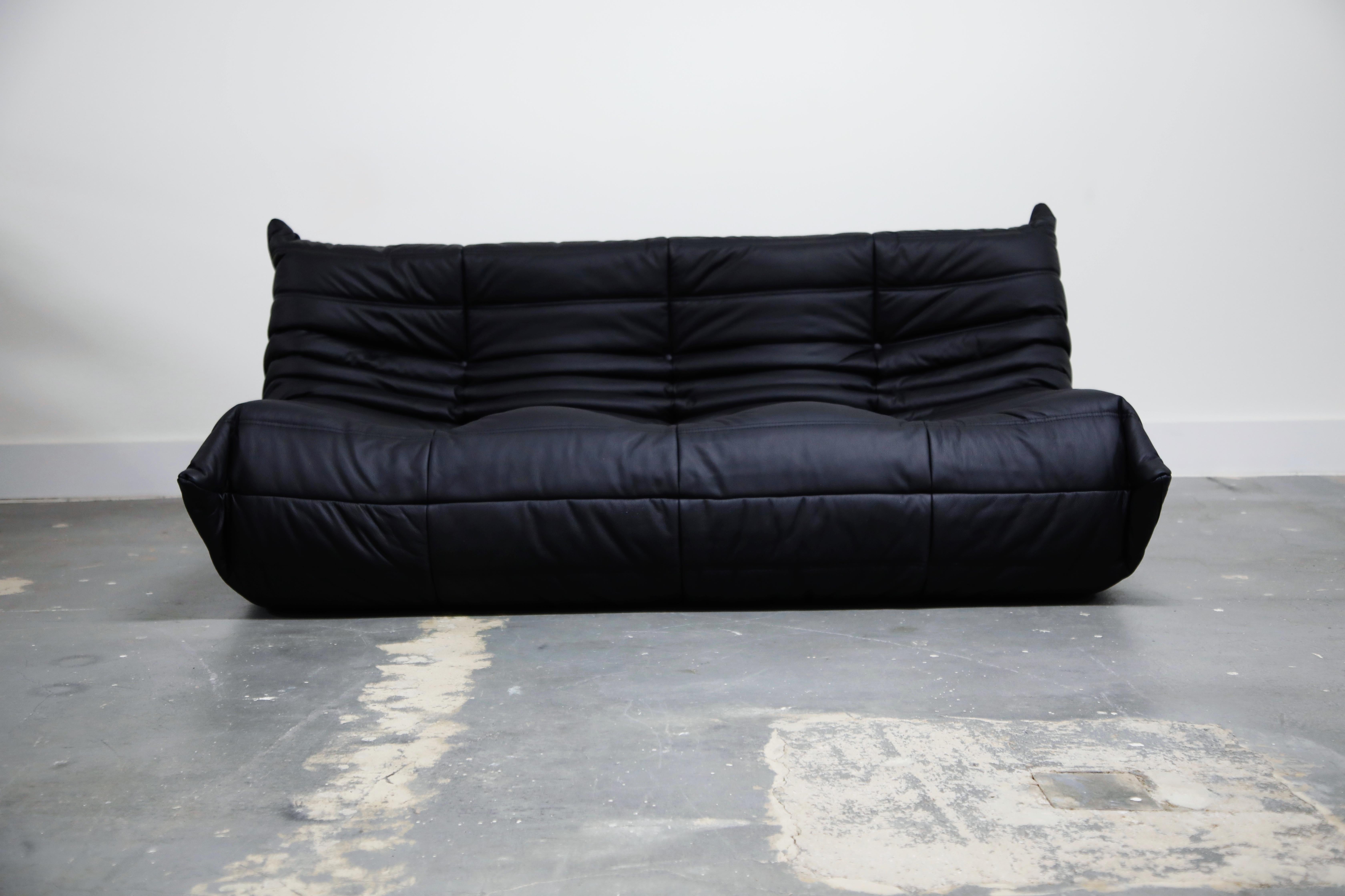This incredible three piece Togo sectional living room set, was designed by Michel Ducaroy in 1973 for Ligne Roset, France. This set was completely restored with new high grade Bovine leather upholstery in a black color, and bottom decking fabric