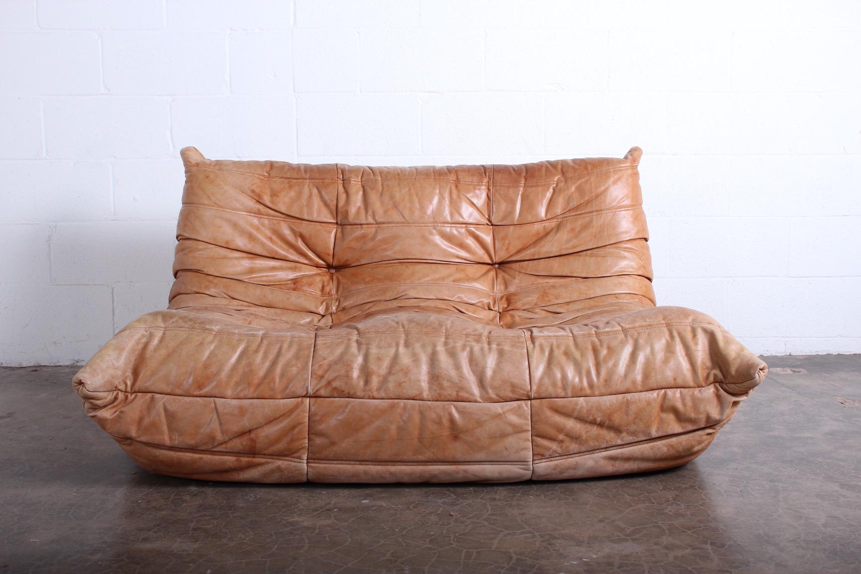 A beautifully patinated original leather Togo settee by Michel Ducaroy for Ligne Roset.