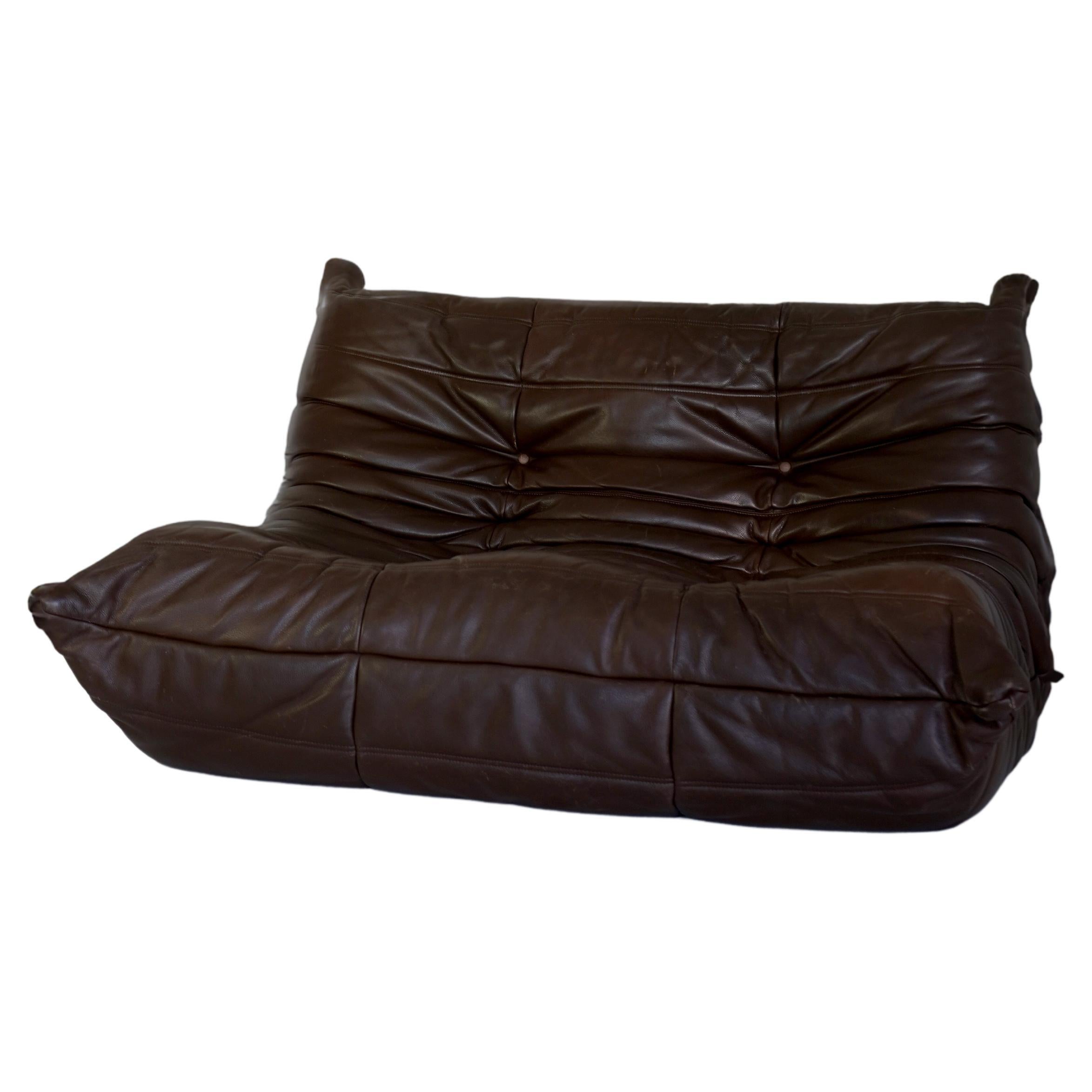 Iconic vintage Togo sofa in brown leather by bohemian French designer Michel Ducaroy. Designed in 1973 and inspired by a scrunched and folded tube of toothpaste. Triple-density polyurethane foam with no internal frame. Tagged Ligne Roset.

Chocolate