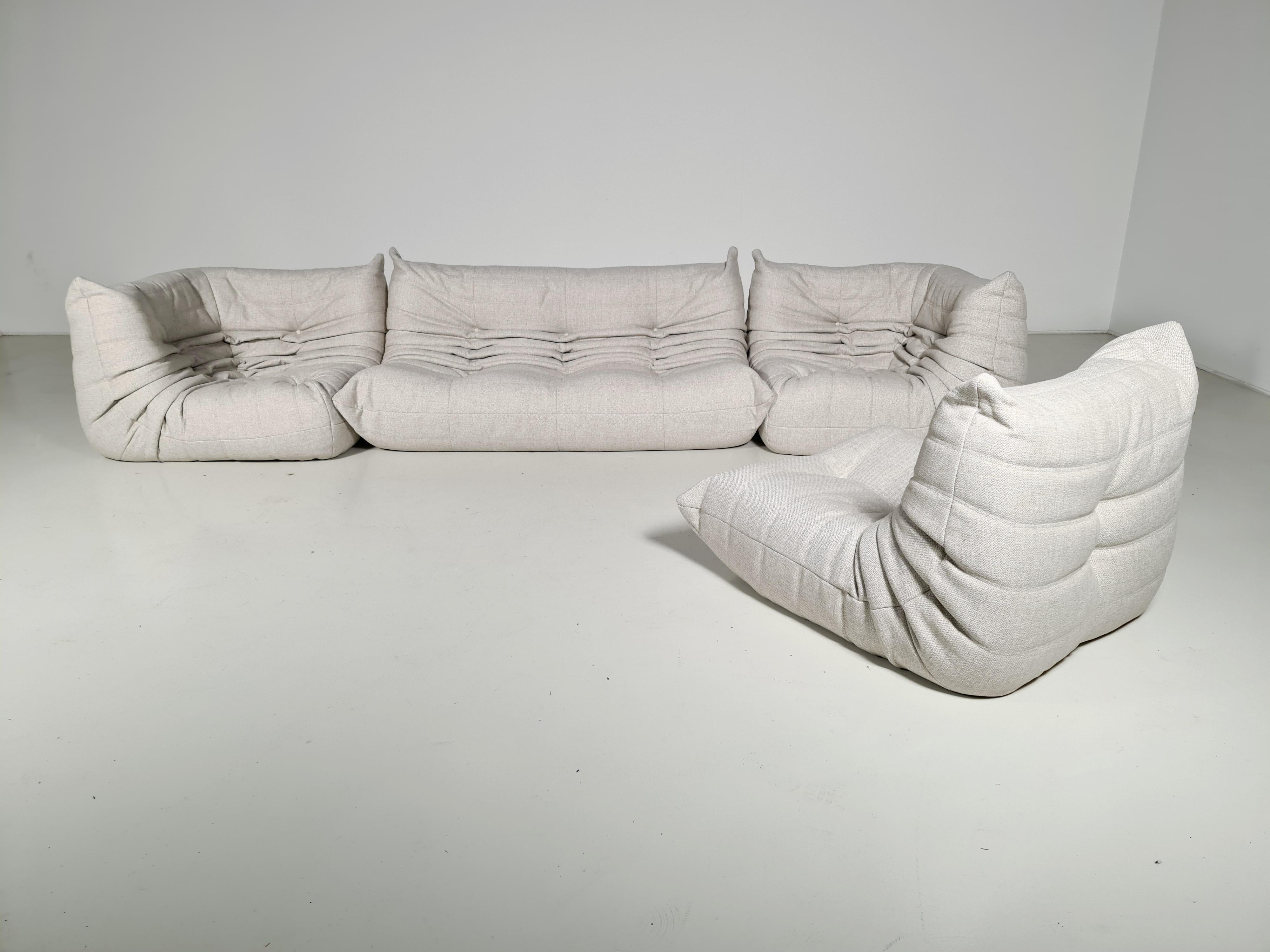 Original Togo vintage sofa designed by Michel Ducaroy in the 1970s for Ligne Roset.
The sofa shows a nice natural color tone and its famous wrinkled cozy design.
Labeled at the back and lined underneath with original fabric. Only the 3-seater has