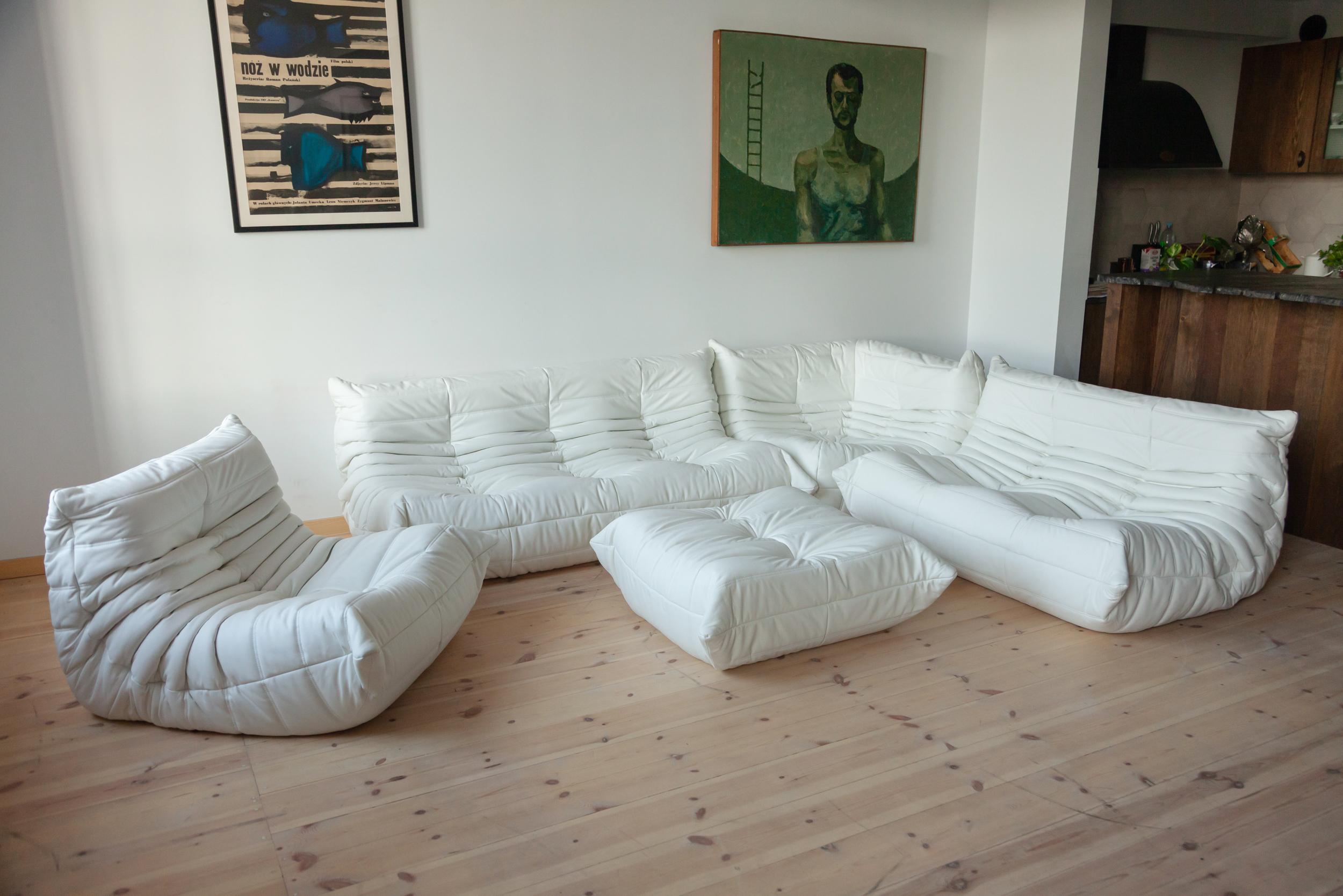 This Togo living room set was designed by Michel Ducaroy in 1973 and was manufactured by Ligne Roset in France. It has been reupholstered in new, great quality white leather and is made up of the following pieces: One three-seat couch (70 x 174 x