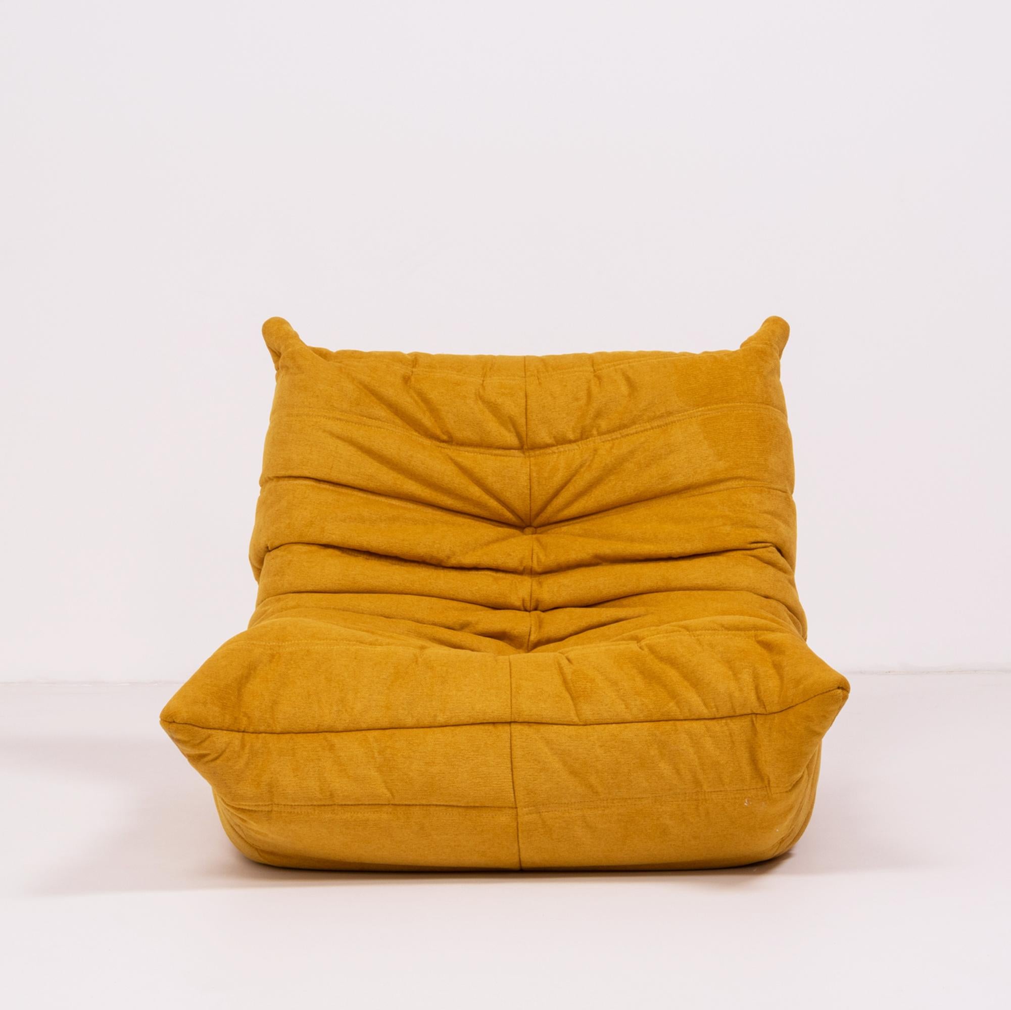 The iconic Togo range, originally designed by Michael Ducaroy for Ligne Roset in 1973, has become a design classic.
 
This fireside chair model has been newly and completely reupholstered in marigold yellow Liberto fabric which can be spot cleaned