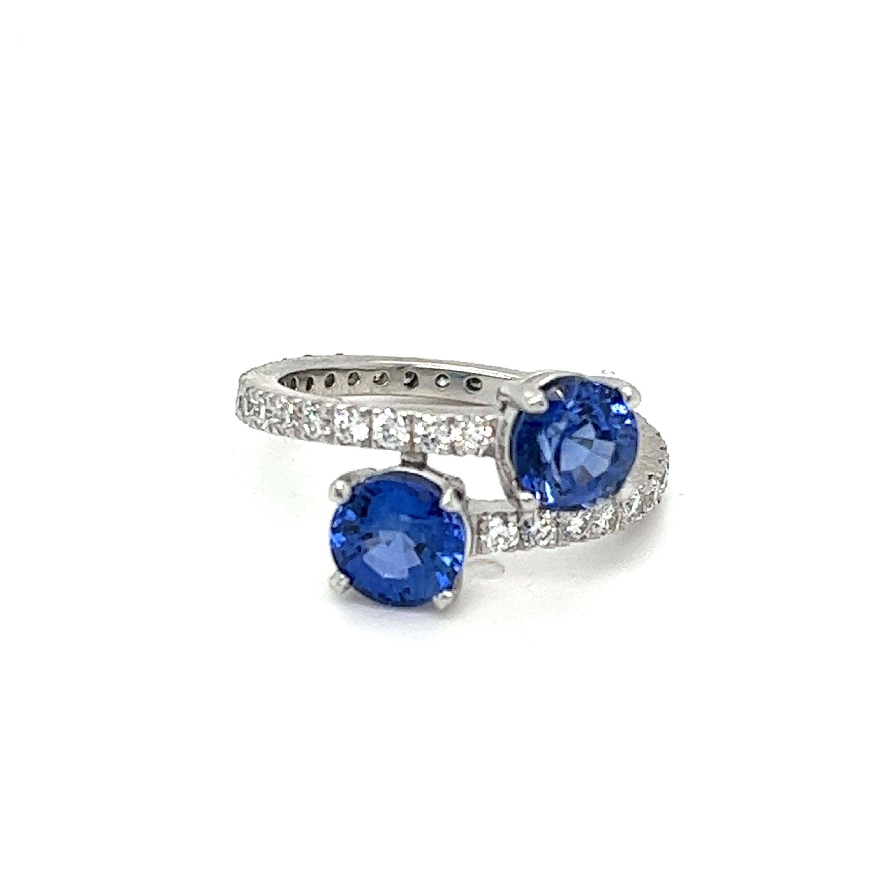 Elegance and symbolism intertwine in this breathtaking Toi et Moi crossover ring, crafted in precious 950 platinum. Featuring two natural earth-mined round sapphires, totaling approximately 2 carats, this ring symbolizes the union of two souls.