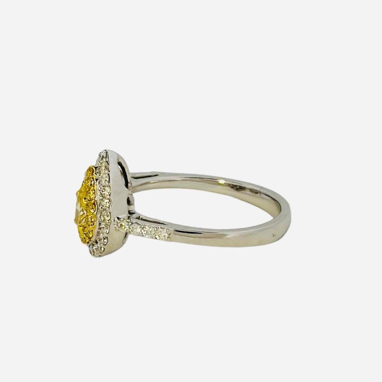 Introducing our exquisite Yellow Pear-Shaped Diamond Ring, a dazzling masterpiece radiating elegance and sophistication, a true testament to exceptional craftsmanship and fancy shaped diamonds. At its core, a brilliant 0.31-carat vibrant yellow