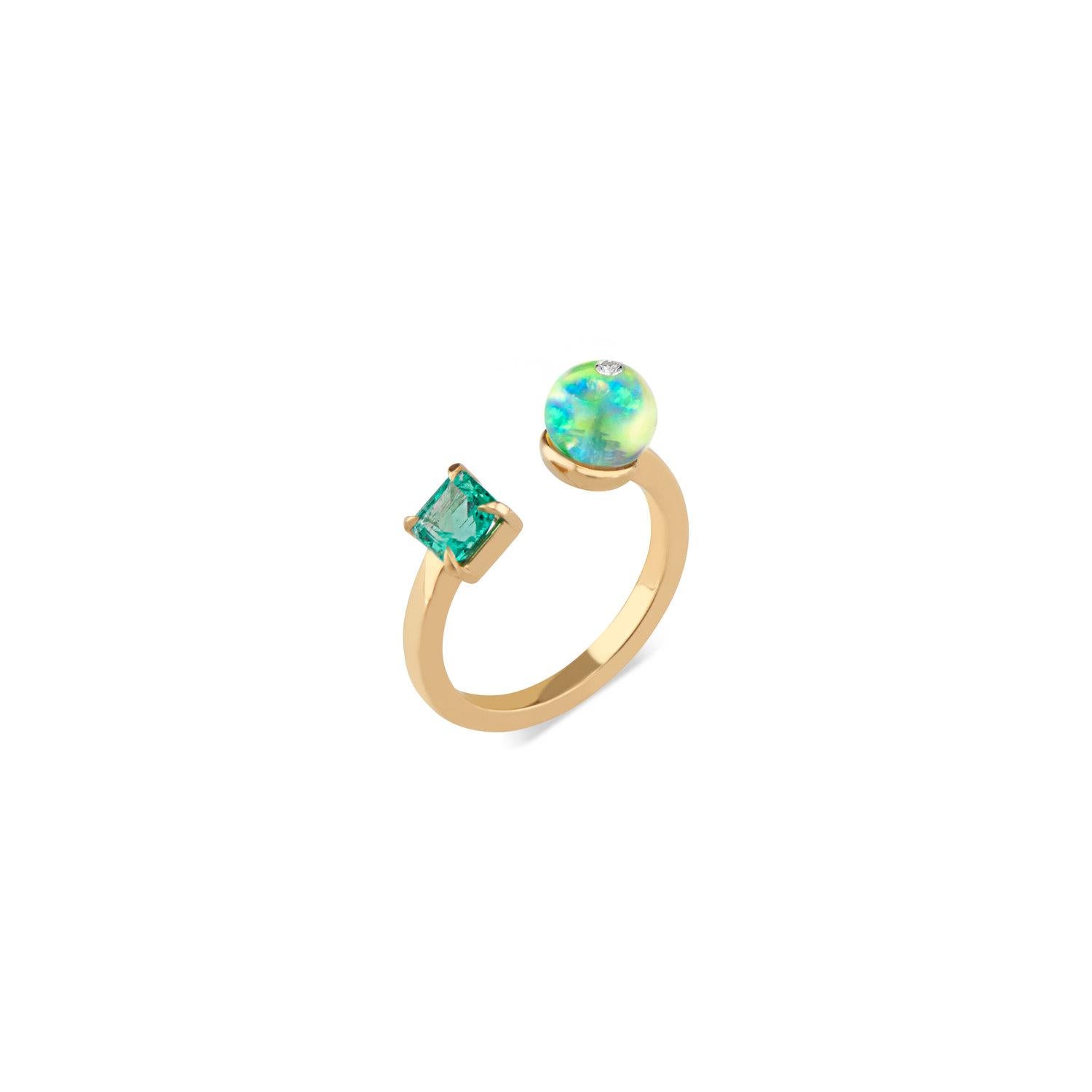 Abstract and artful, Ri Noor's Toi Moi Opal Bead Emerald and Diamond Ring creates a dynamic contrast between geometric shapes. The squared band of 18k yellow gold wraps around the wearer's finger, presenting a vivid green emerald on one side and, on