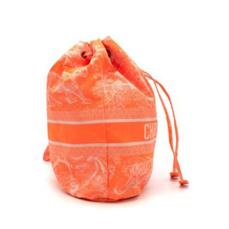 Dior Flourescent Orange Toile de Jouy navy travel pouch
 
 -'CHRISTIAN DIOR PARIS' signature on the front
 -1 removable strap
 -Drawstring closure on the top
 -1 interior compartment
 -t features the Toile de Jouy Reverse motif
 
 Material: 
 
