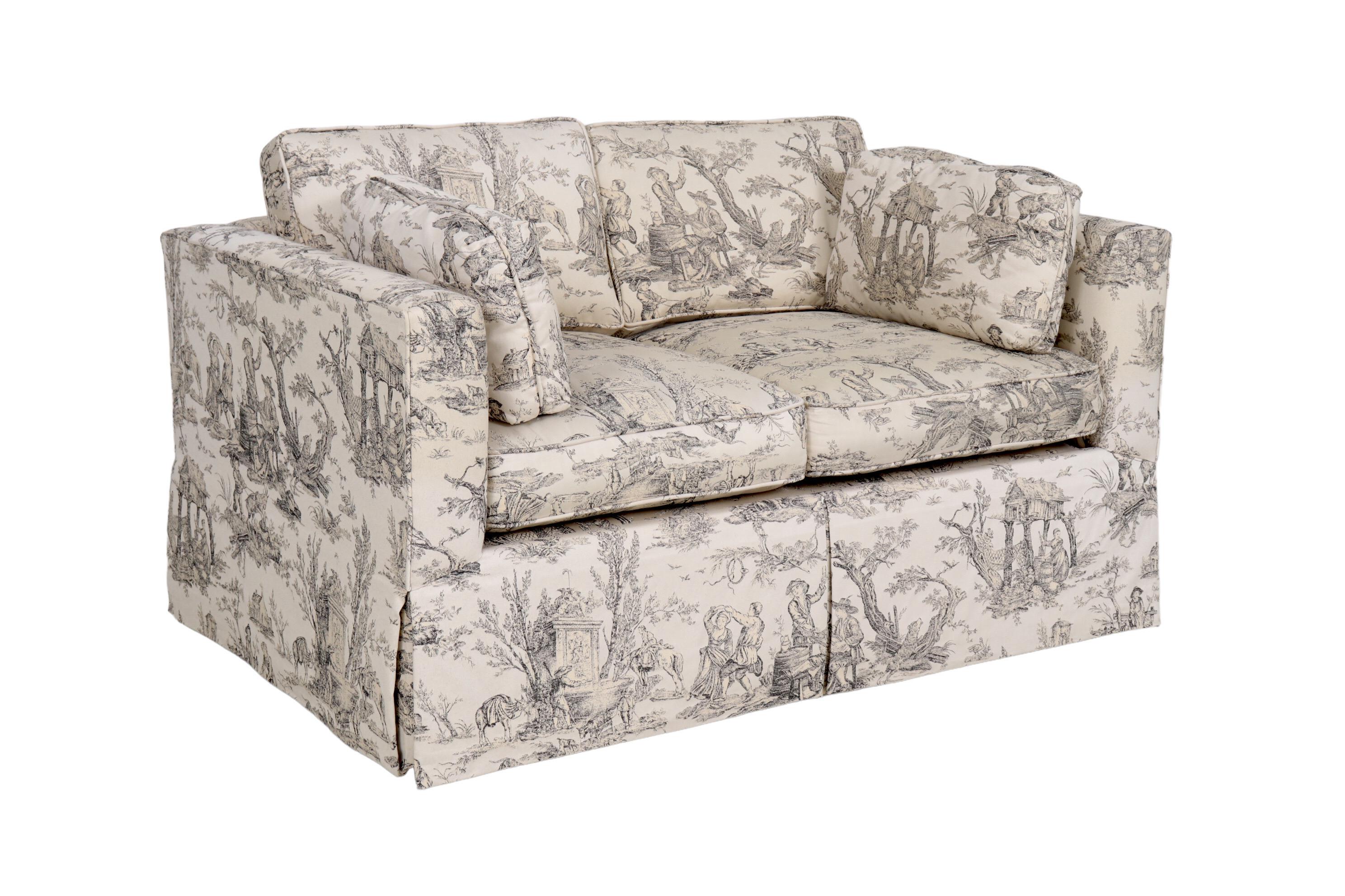 A Tuxedo style loveseat sofa beautifully upholstered in a toile jacquard titled “L' Abreuvoir” or ‘The Drinking Trough’ designed by Jean-Baptiste Huet, and originally printed by Manufacture Royale de Oberkampf, Jouy-en-Josas, France, circa 1792.