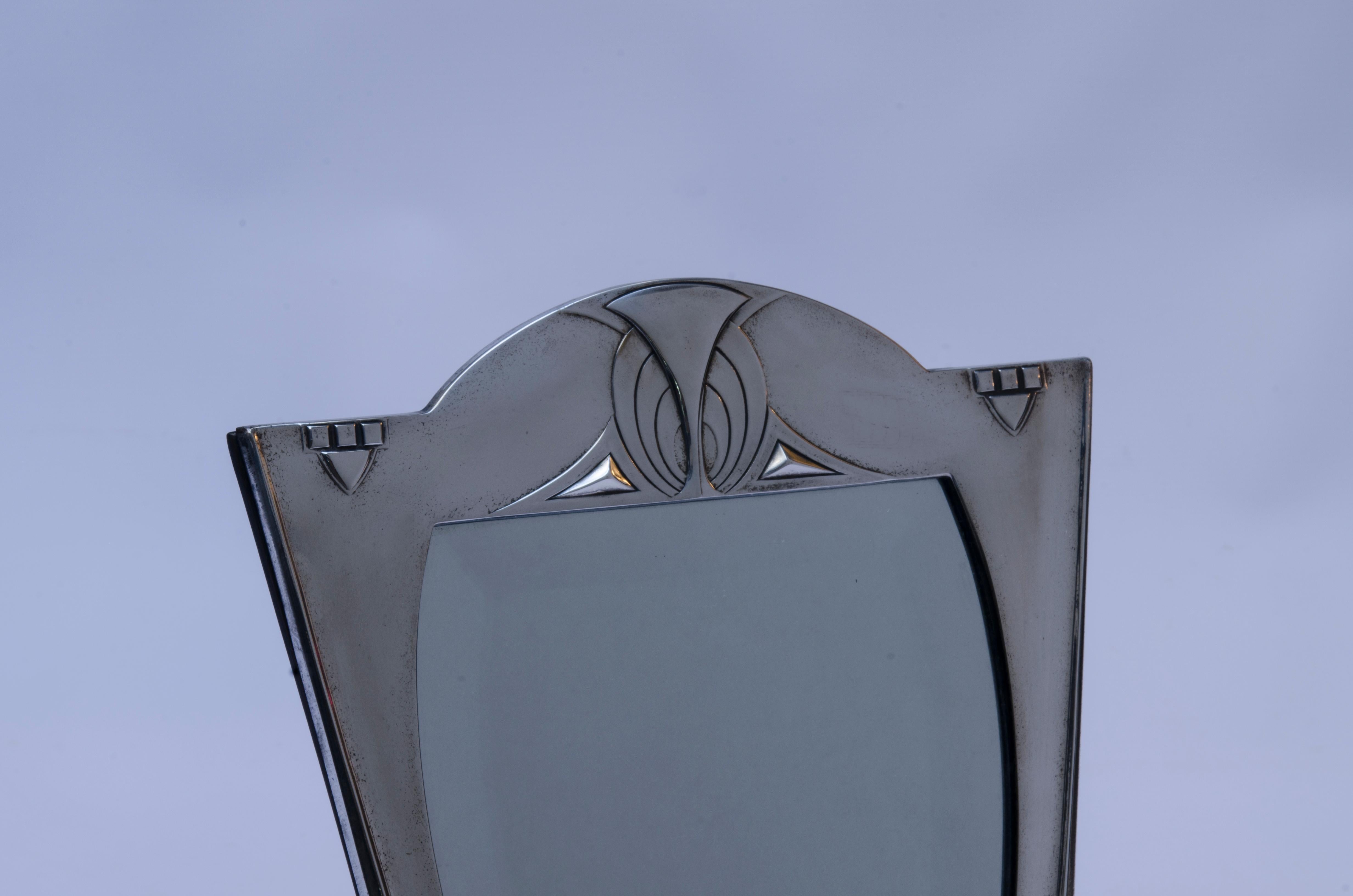 “Model 84” toilet mirror made of silver-plated bronze and beveled mirror, manufactured by WMF- Württembergische Metallwarenfabrik (1853 to the present). Signed WMF with ostrich, ace, I/0.

Germany, CIRCA 1900.

Graham Dry (1906), “Art Nouveau