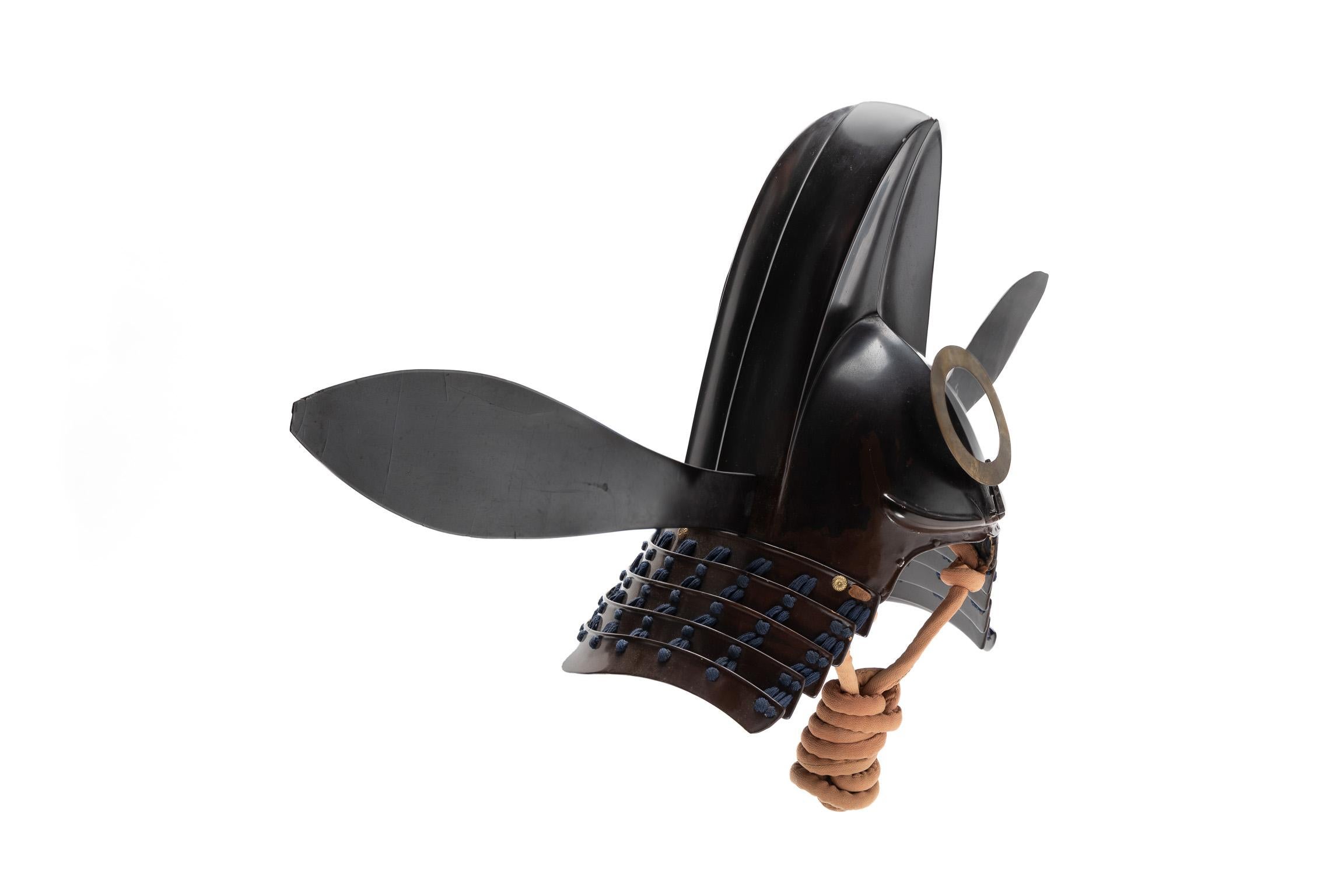 Tokanmuri kabuto
Samurai helmet in the shape of a court cap

Momoyama to early Edo Period

17th century

 

The wearing of helmets that reproduced the shapes of traditional headgear became common among members of the military class by the