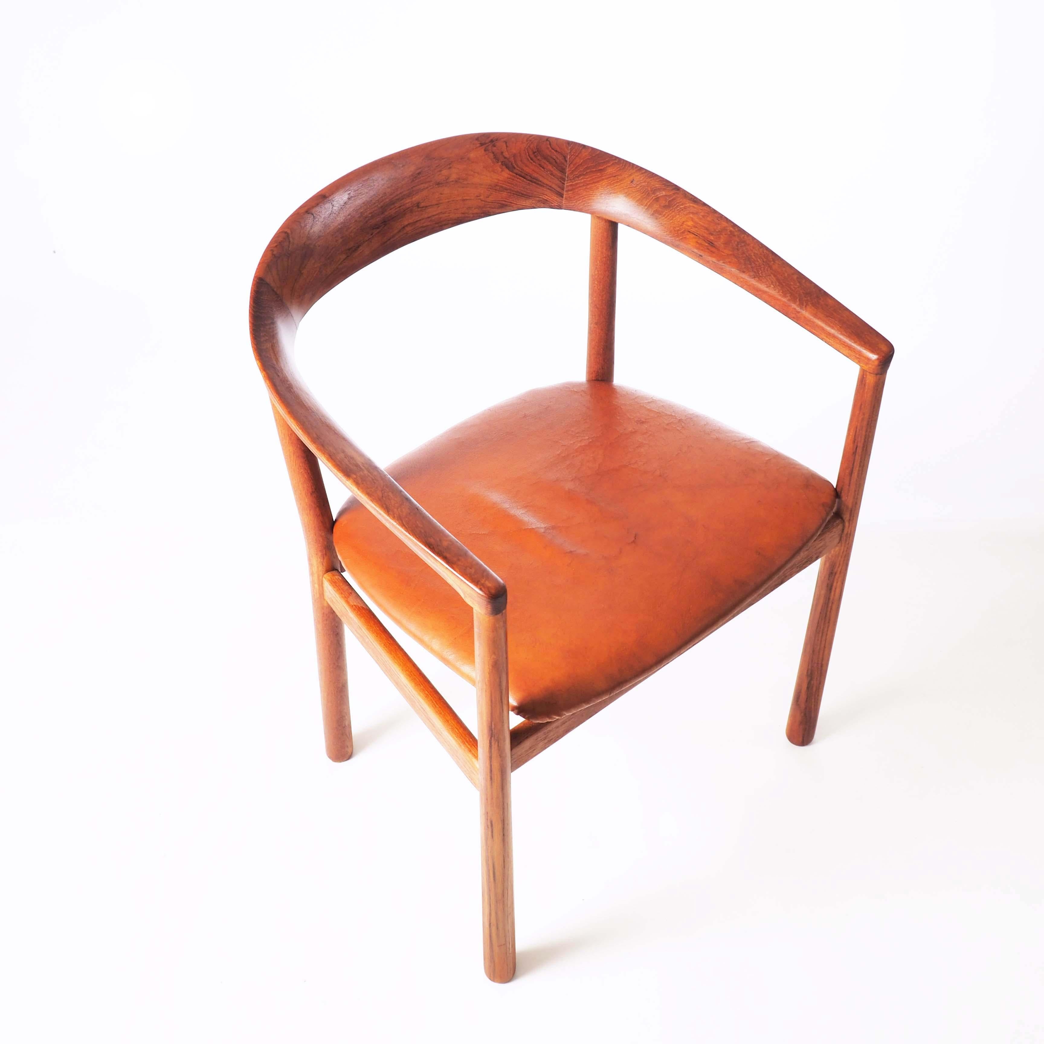 This stylish chair was designed by the Carl-Axel Acking for the Swedish Embassy in Tokyo in 1959. This piece is in solid teak and natural leather.