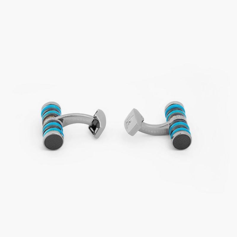 Tokyo Rings Cylinder cufflinks with blue enamel and gunmetal finish

These sports inspired cufflinks feature a series of coloured rings wrapped around a a rhodium or gunmetal plated base metal cylinder cufflink. Each of the individual rings is hand