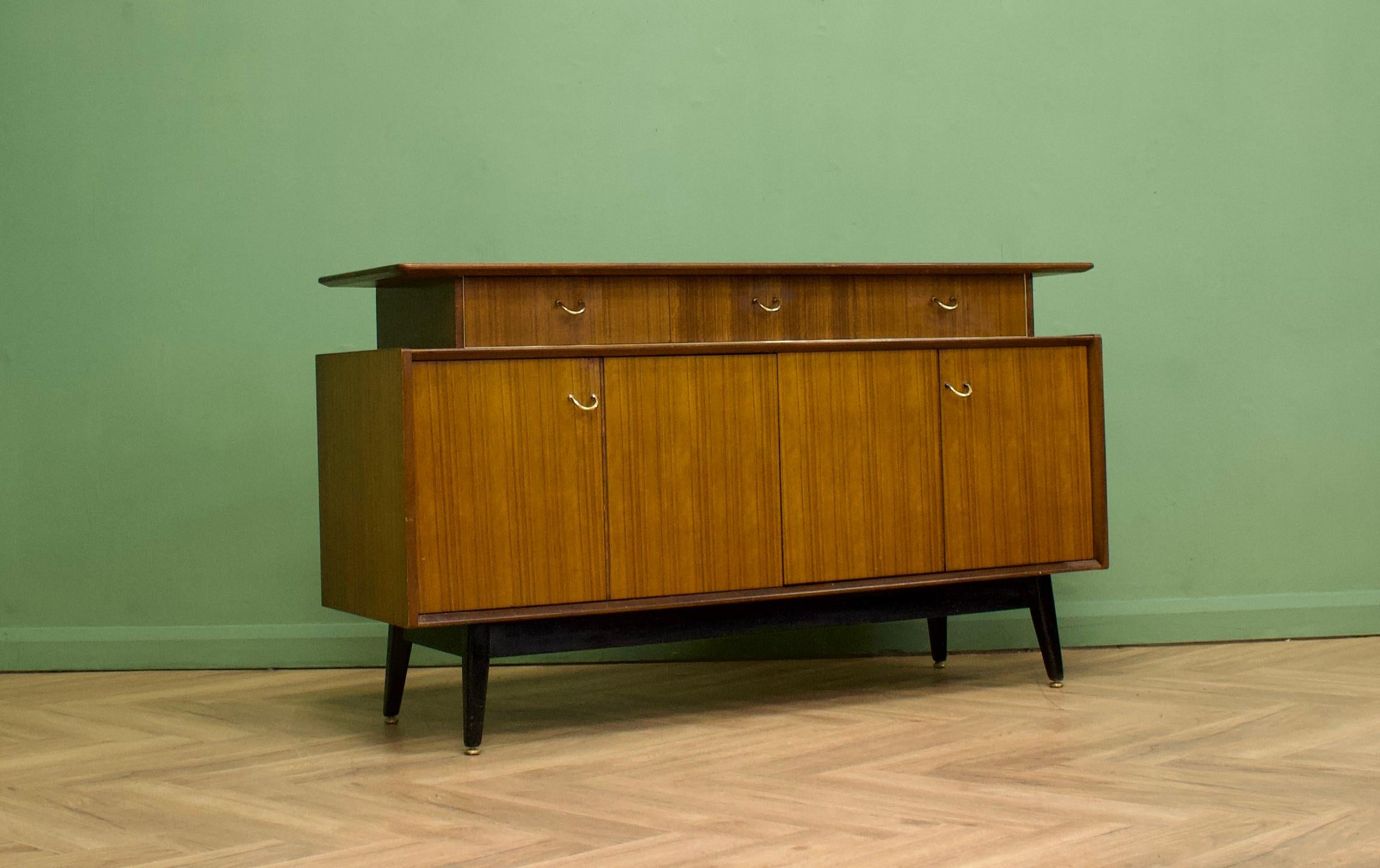 - Mid century Tola sideboard.
- Manufactured in the UK by G Plan 
- Featuring bi-fold doors.
  