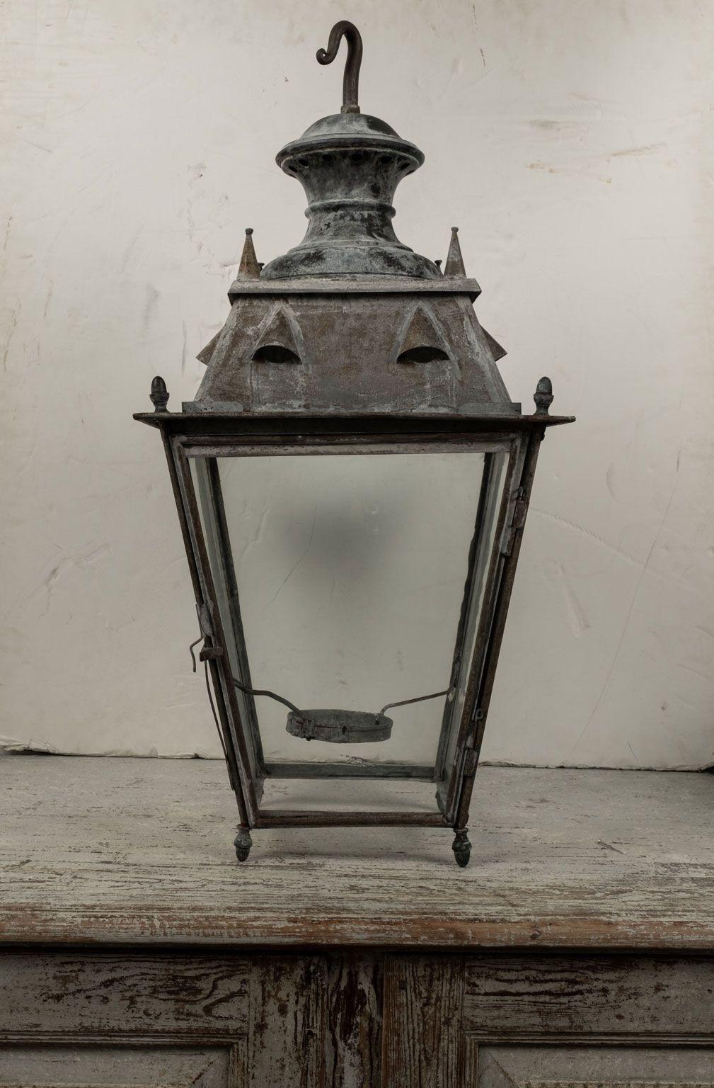 Tole and glass French lantern dating to 19th century. Four-sided iron frame, tole top and glass paneled sides. Not wired for electricity, but can be wired, or fitted for usage with gas, for an additional cost.