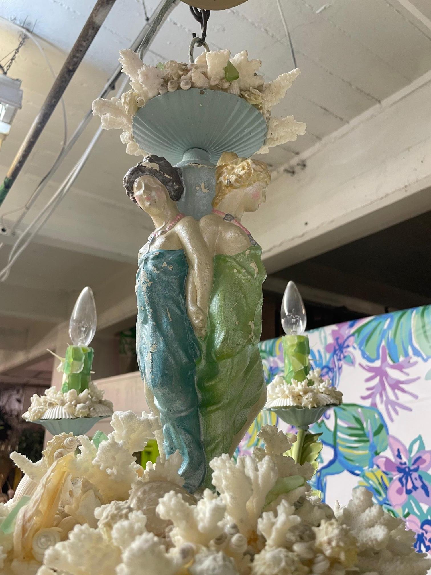 Handmade chandelier by a South Florida artist features an original tole chandelier decorated with seashells, corals, and vintage figurines. Truly unique. Good condition with minor imperfections consistent with age.